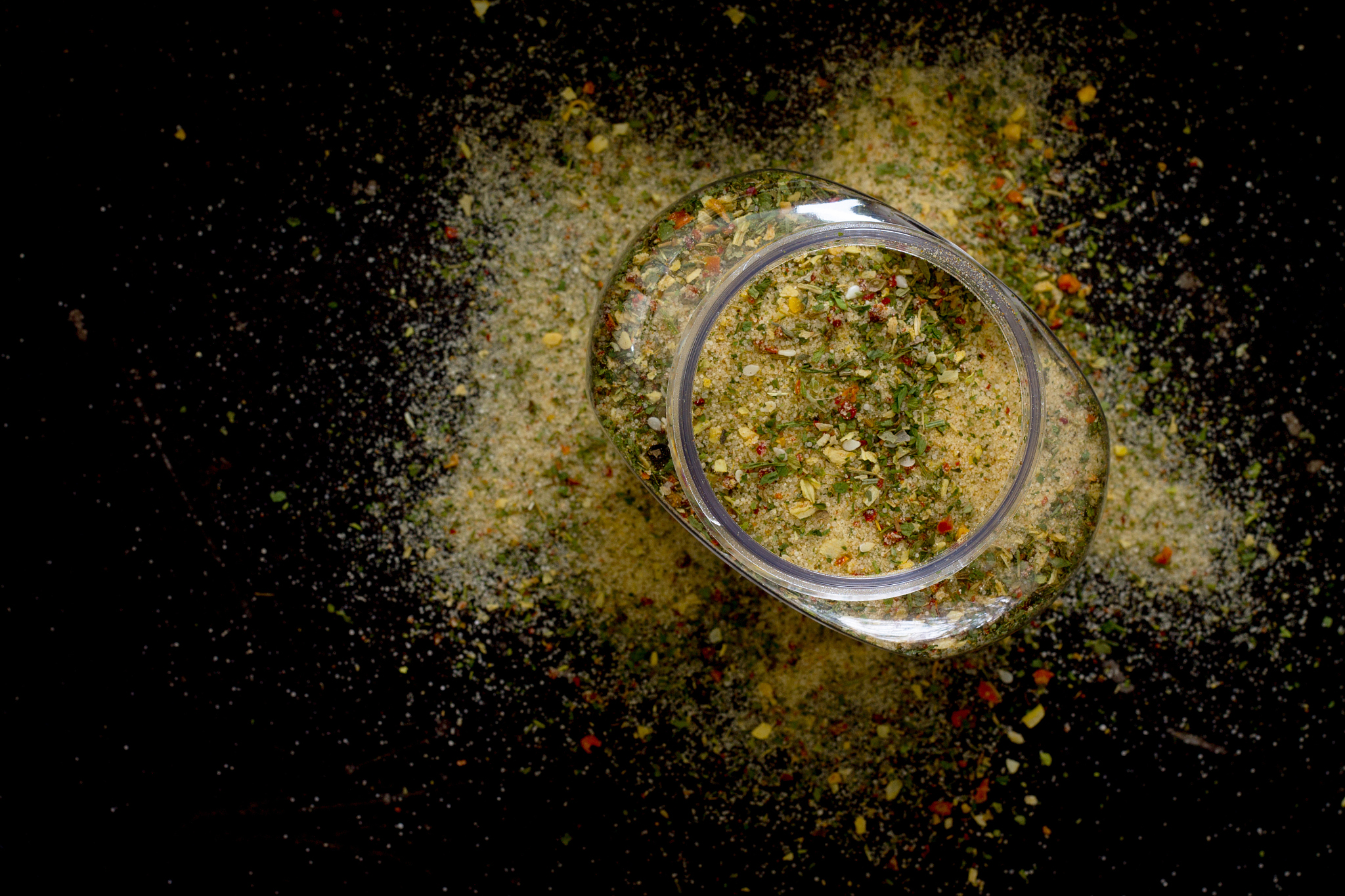 salt and spices in a pot on a dark background