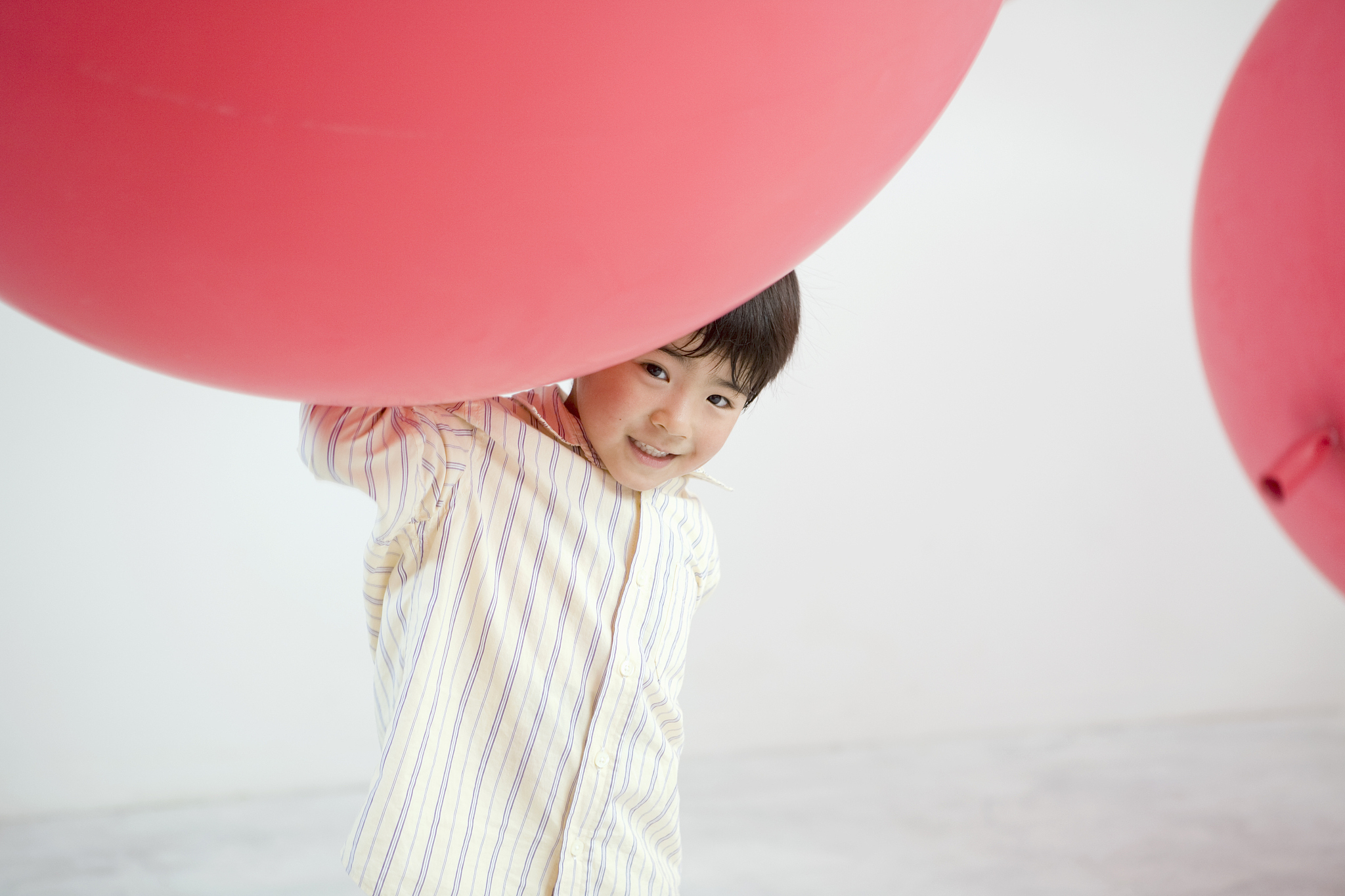 children playing with big red ballons