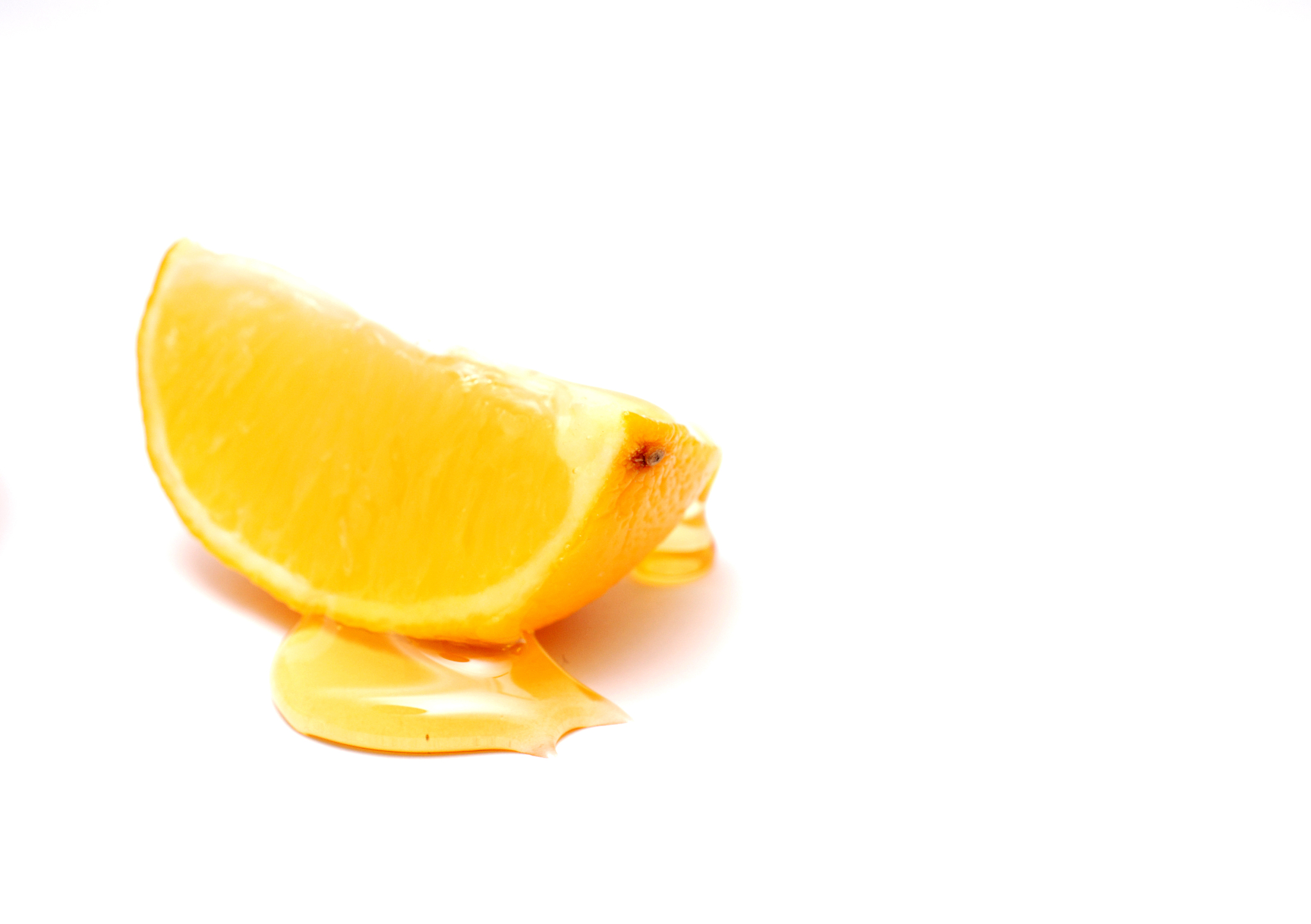 slice of lemon and honey , shallow dof, white background