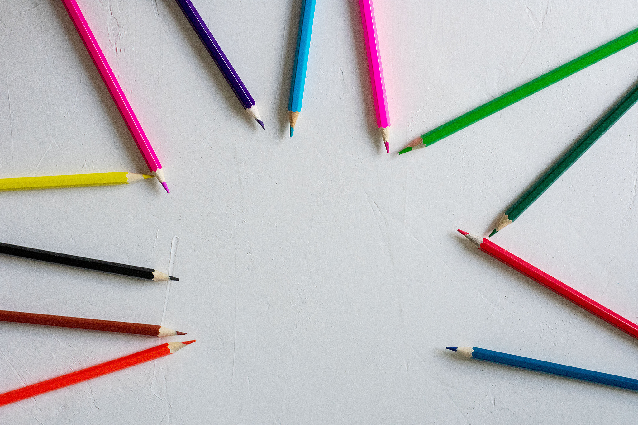 many colored pencils lie on a white background. copy spase. the 