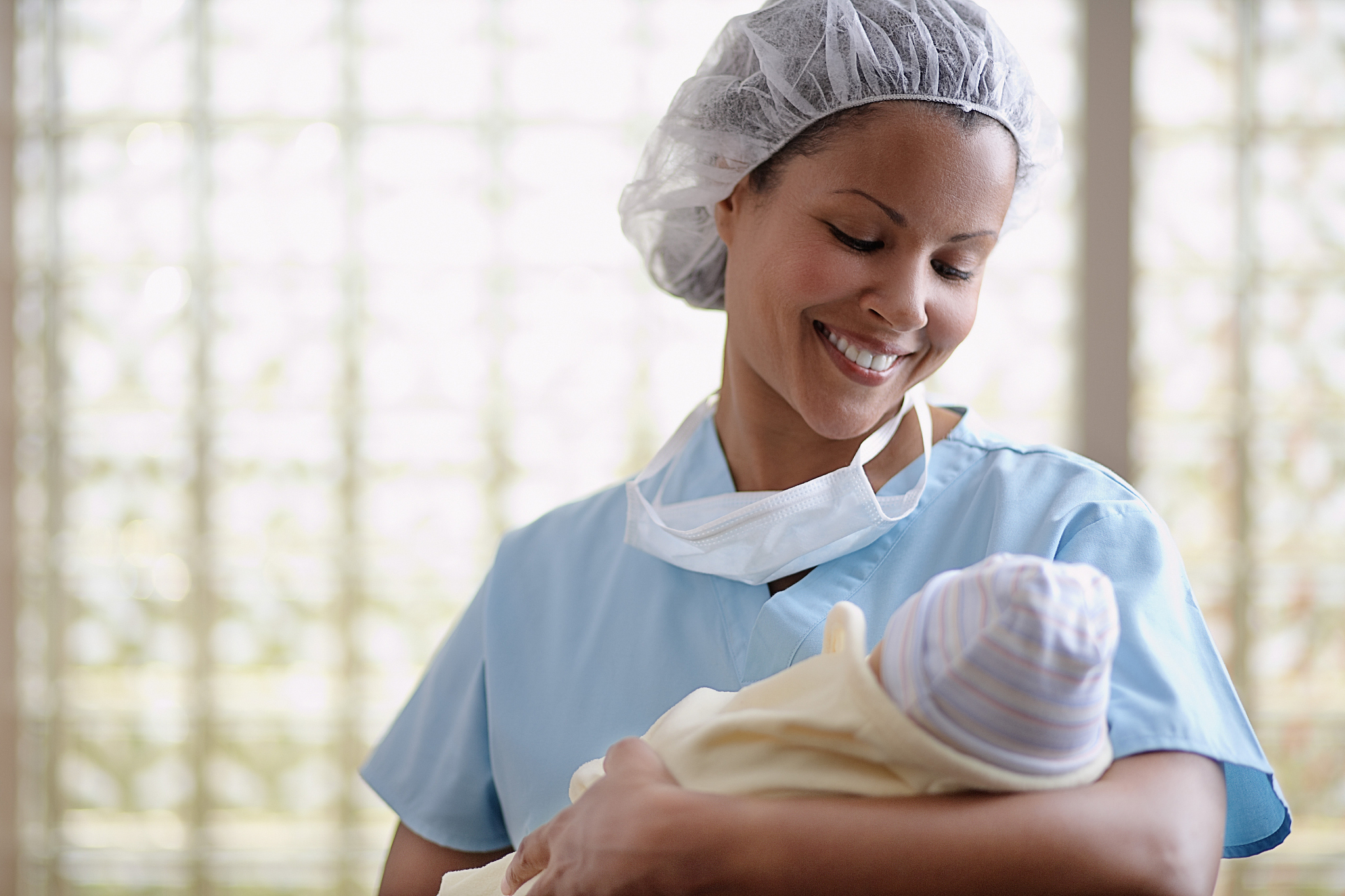 nurse holding newborn