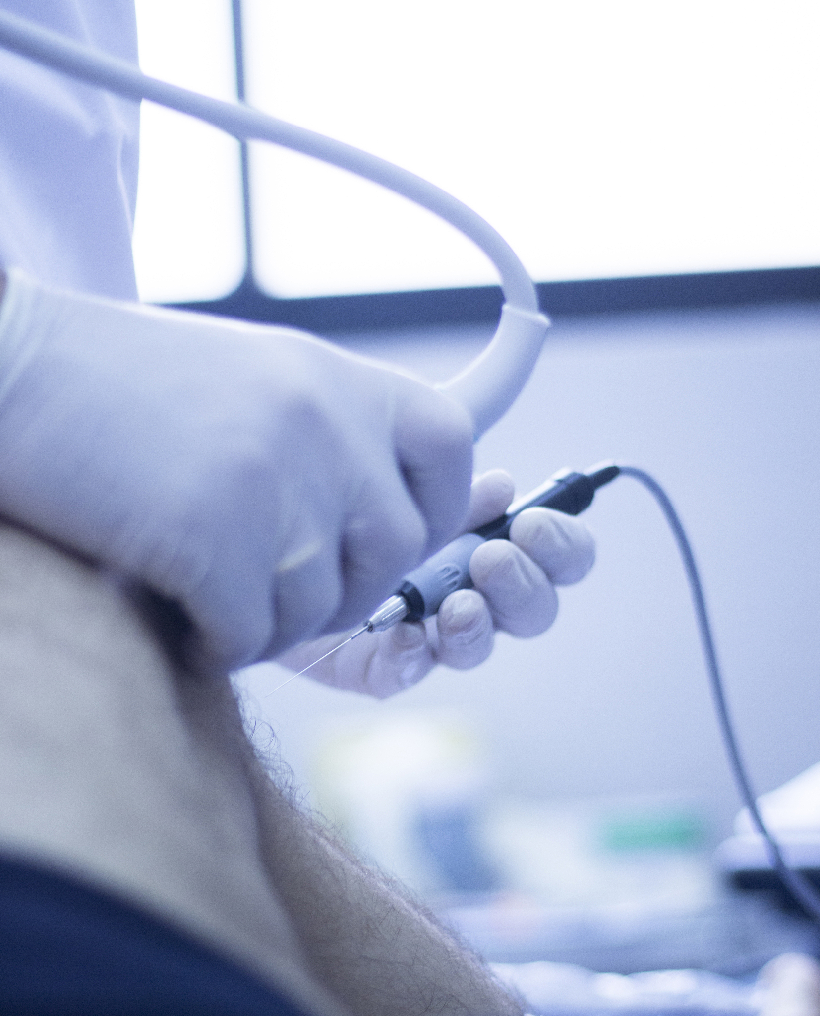 cropped hands of doctor injecting patient in hospital