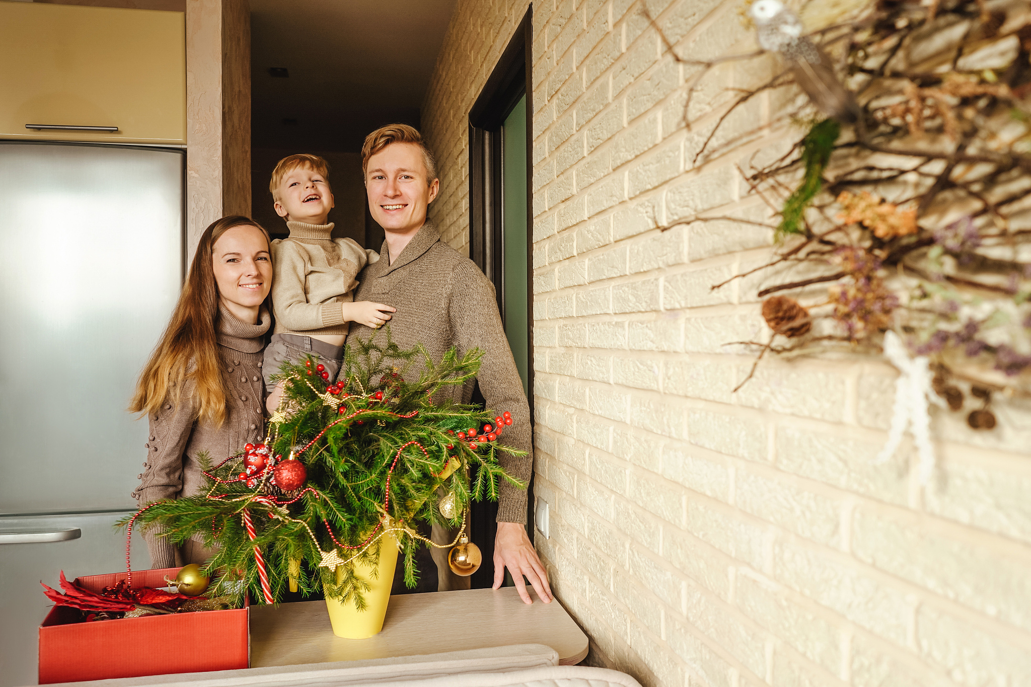 happy family near christmas fir branches.
