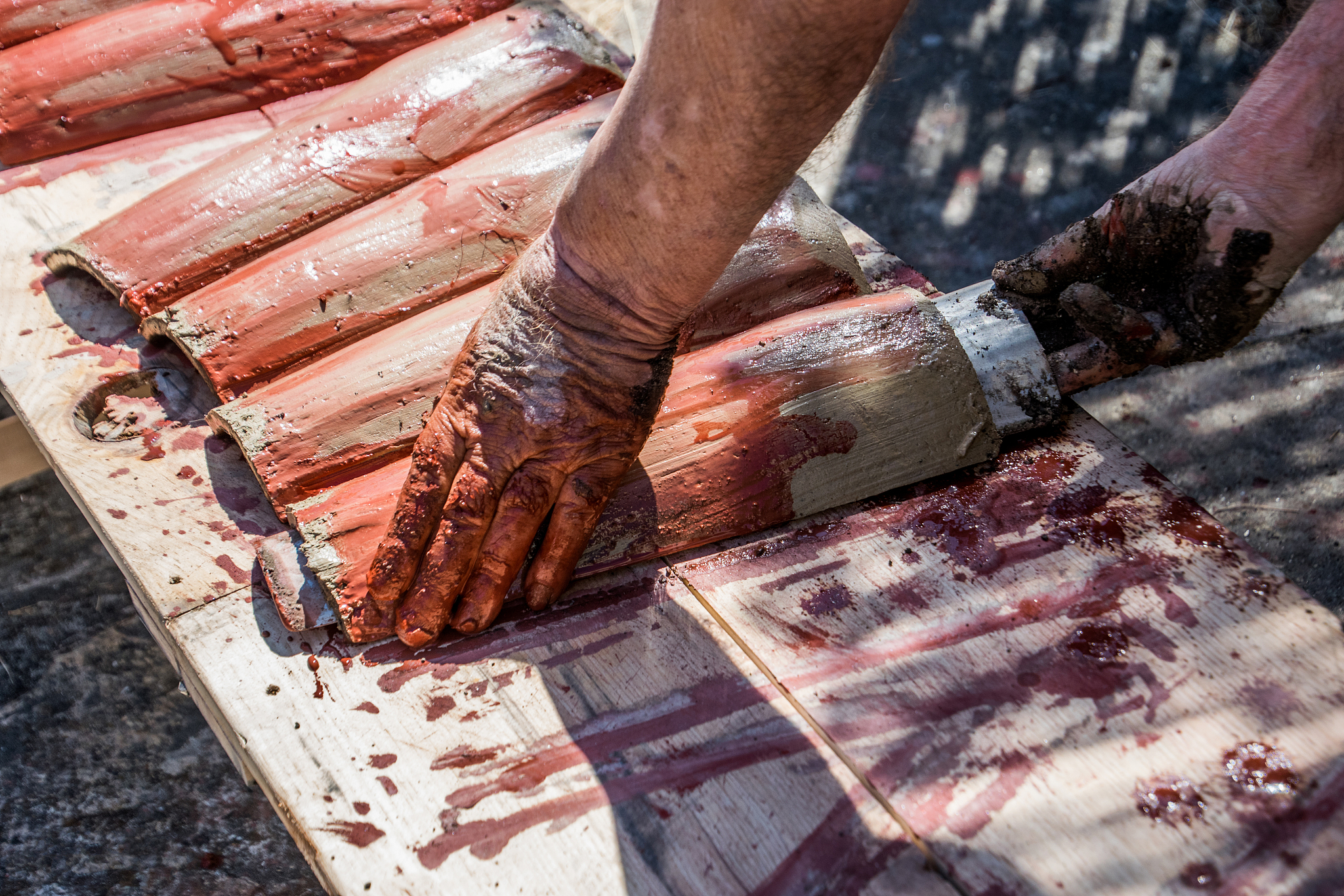 translate 用针线将手工品缝在胸针上或者用热熔胶粘在胸针上 into English