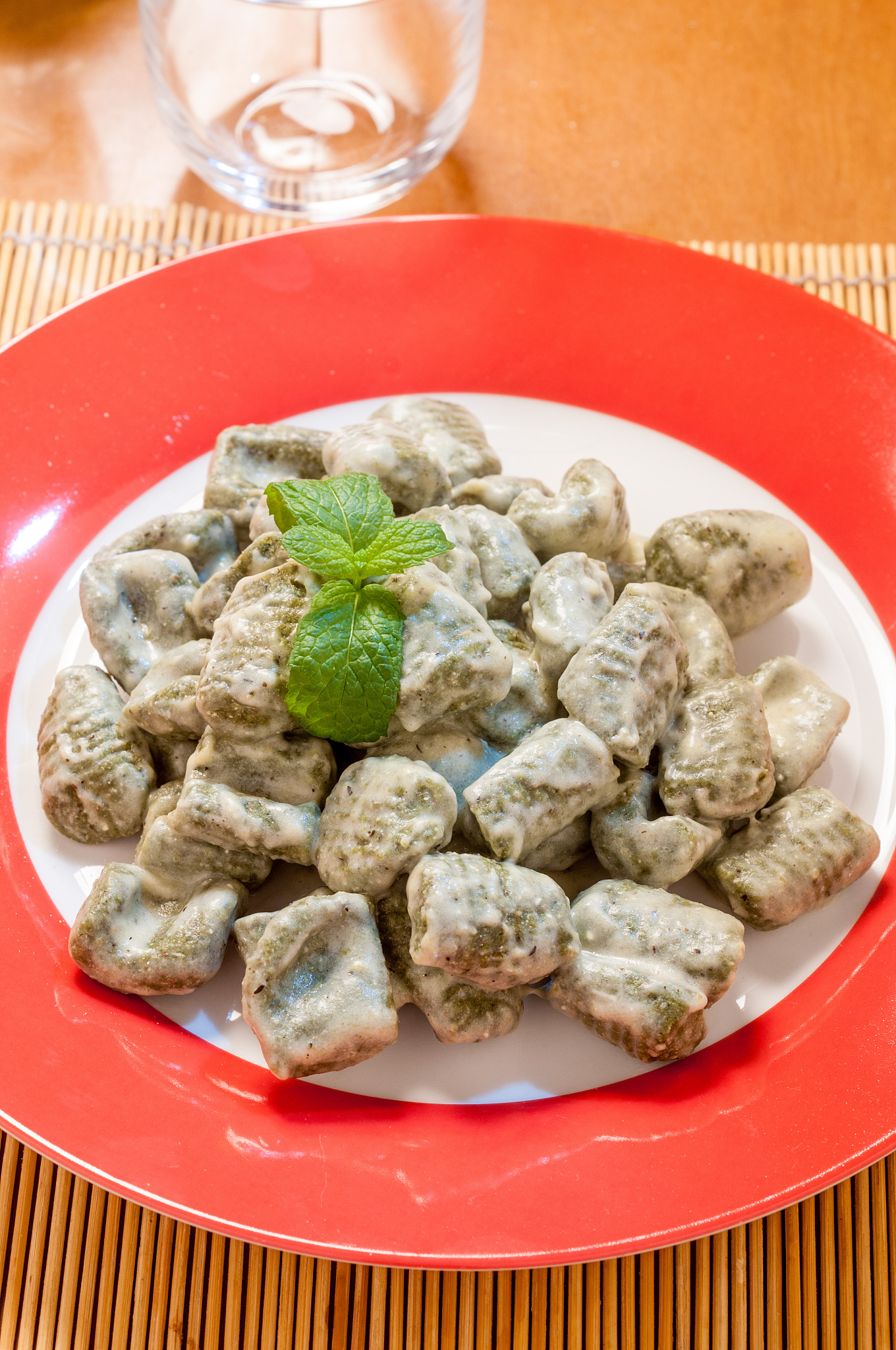 plate of green gnocchi with spinach