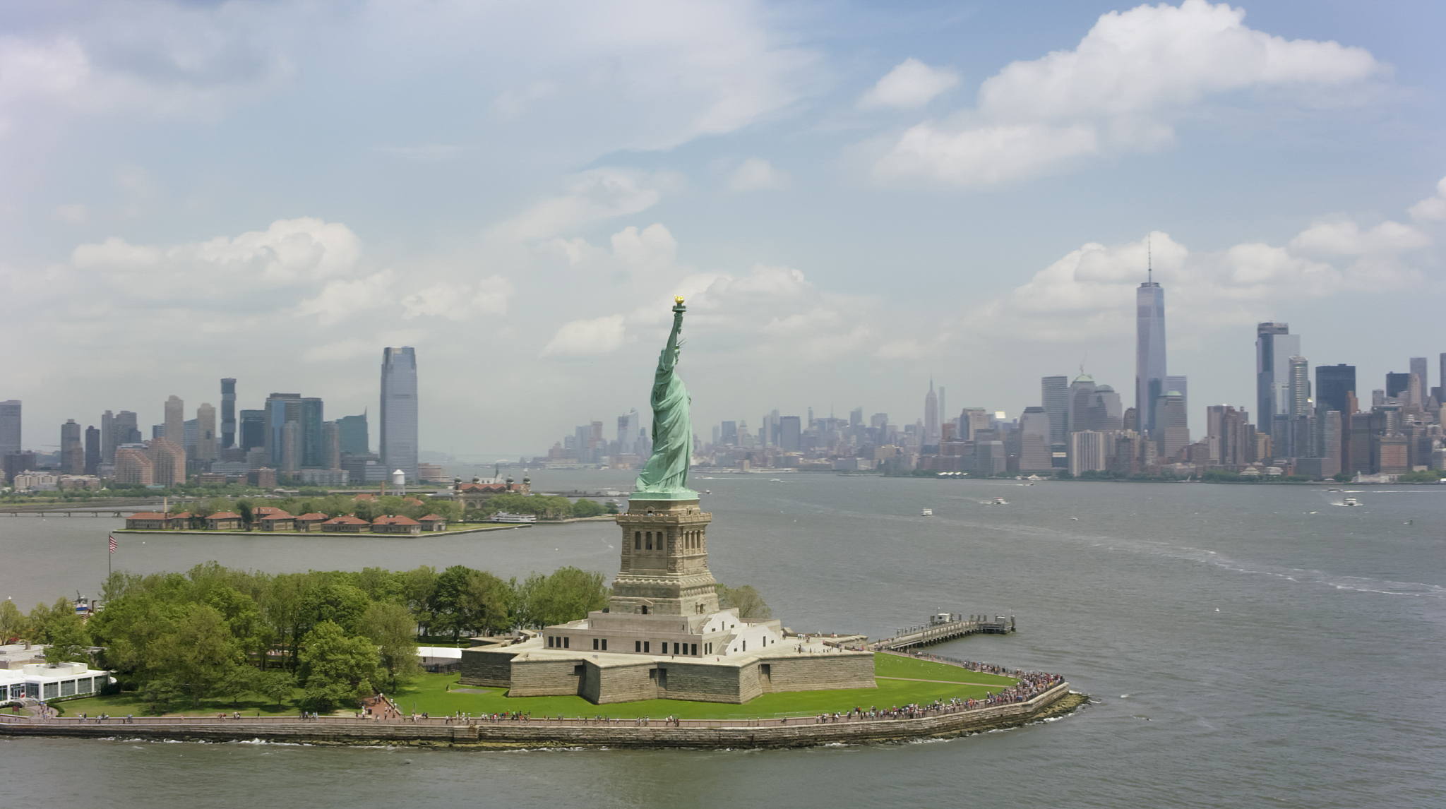 statue of liberty with governors island and manhattan