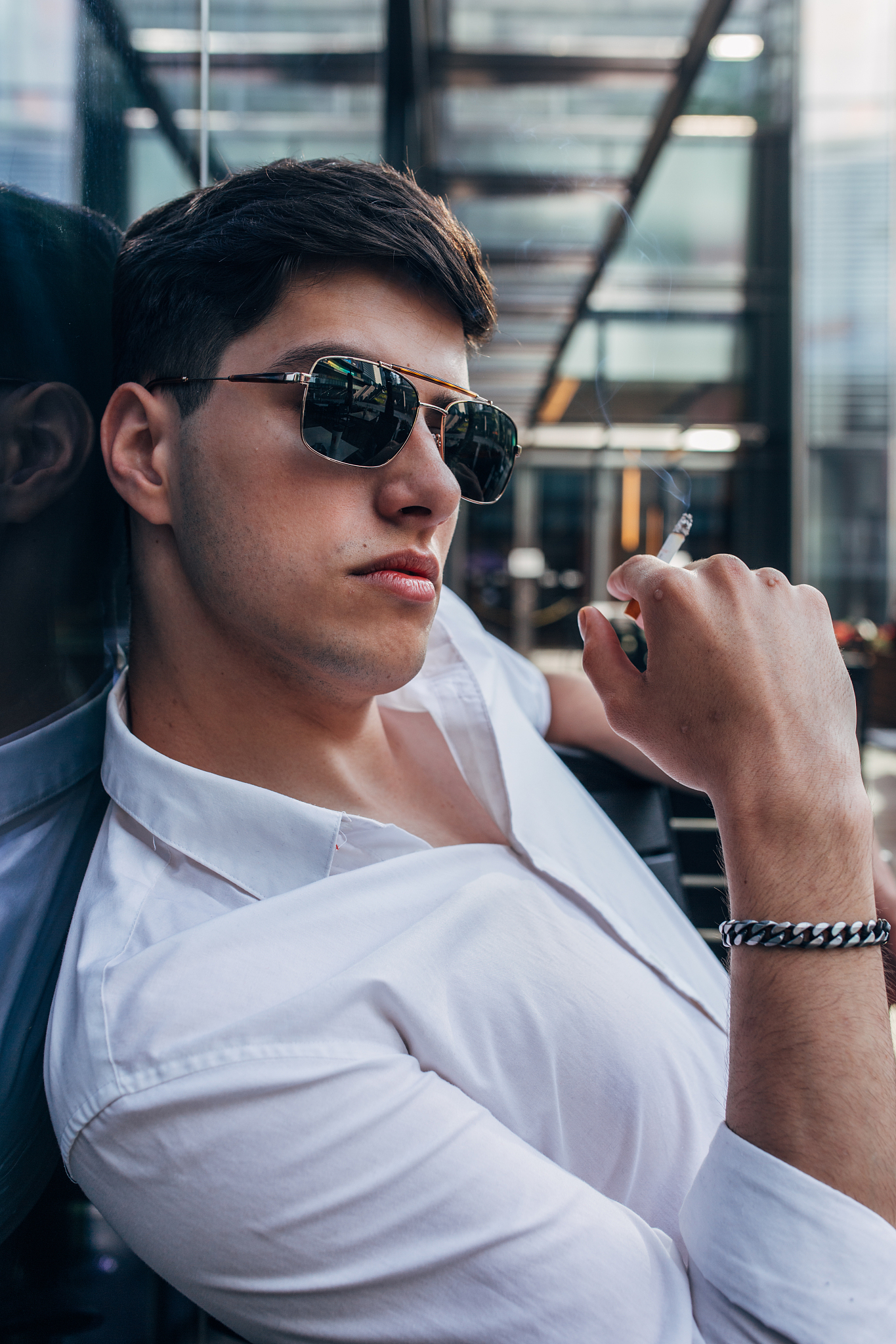 young man with sunglasses smoking cigarette