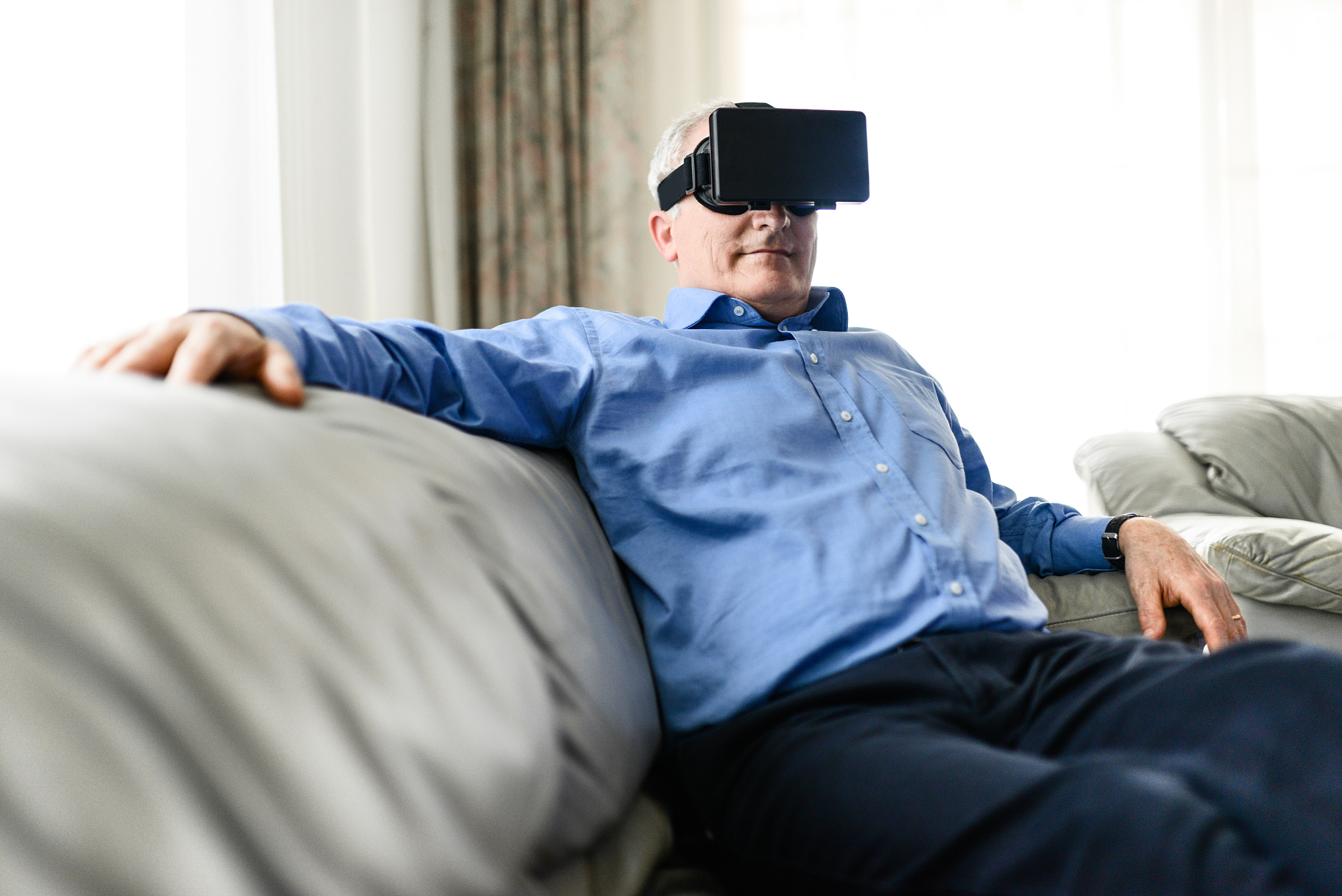 businessman watching a movie on the couch