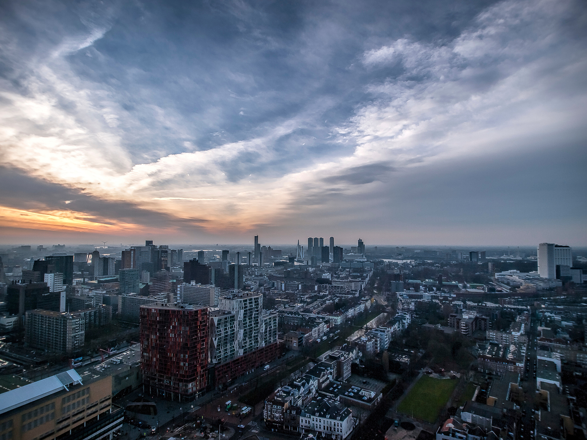 high angle view of modern buildings against sky during sunset