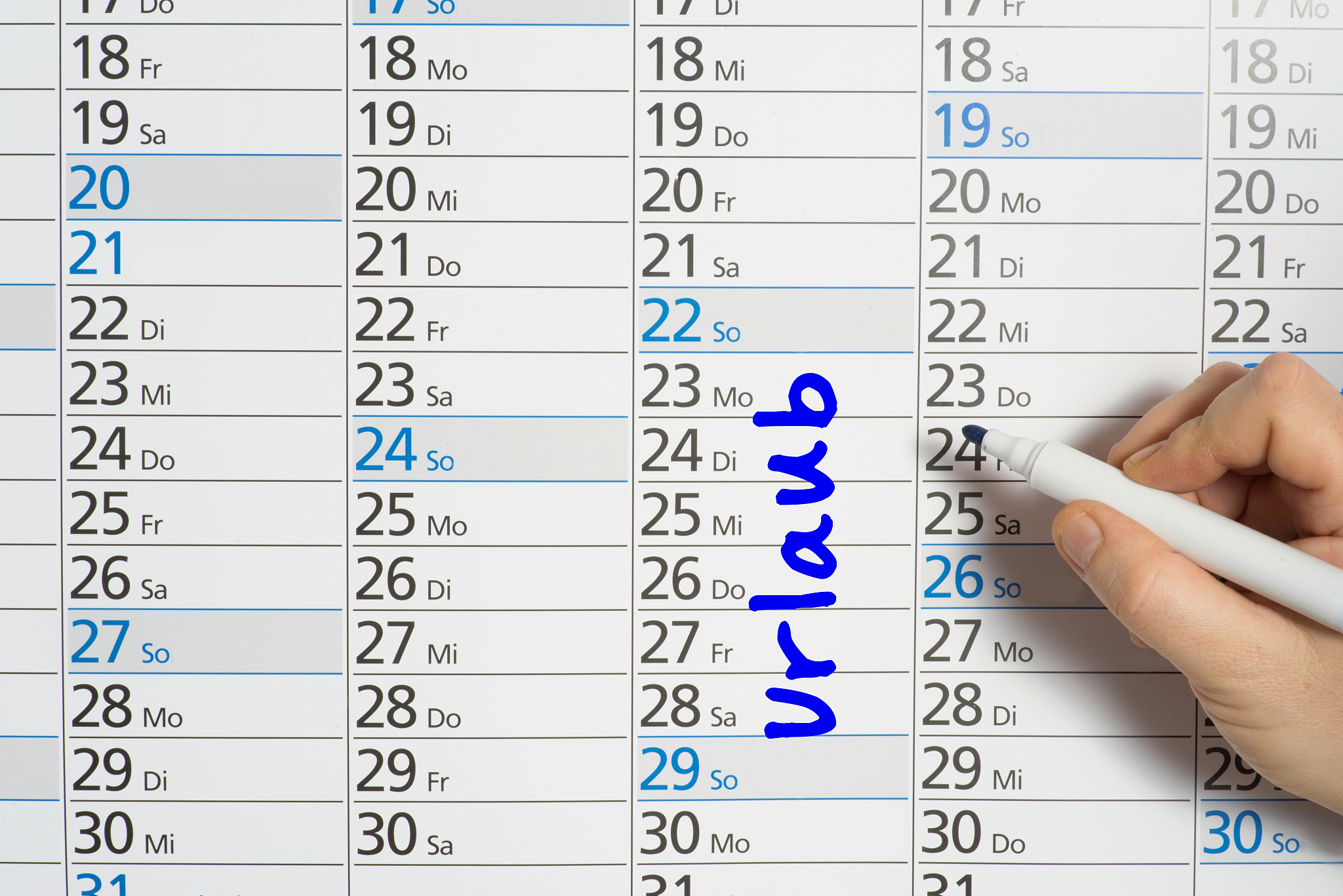 a man stands on a wall calendar and enters his holiday