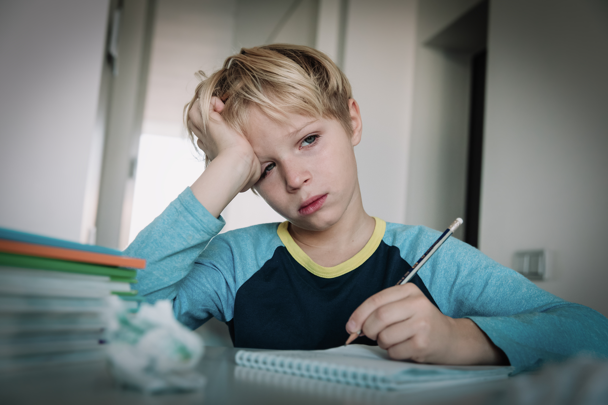 little boy tired stressed of doing homework, bored, exhausted