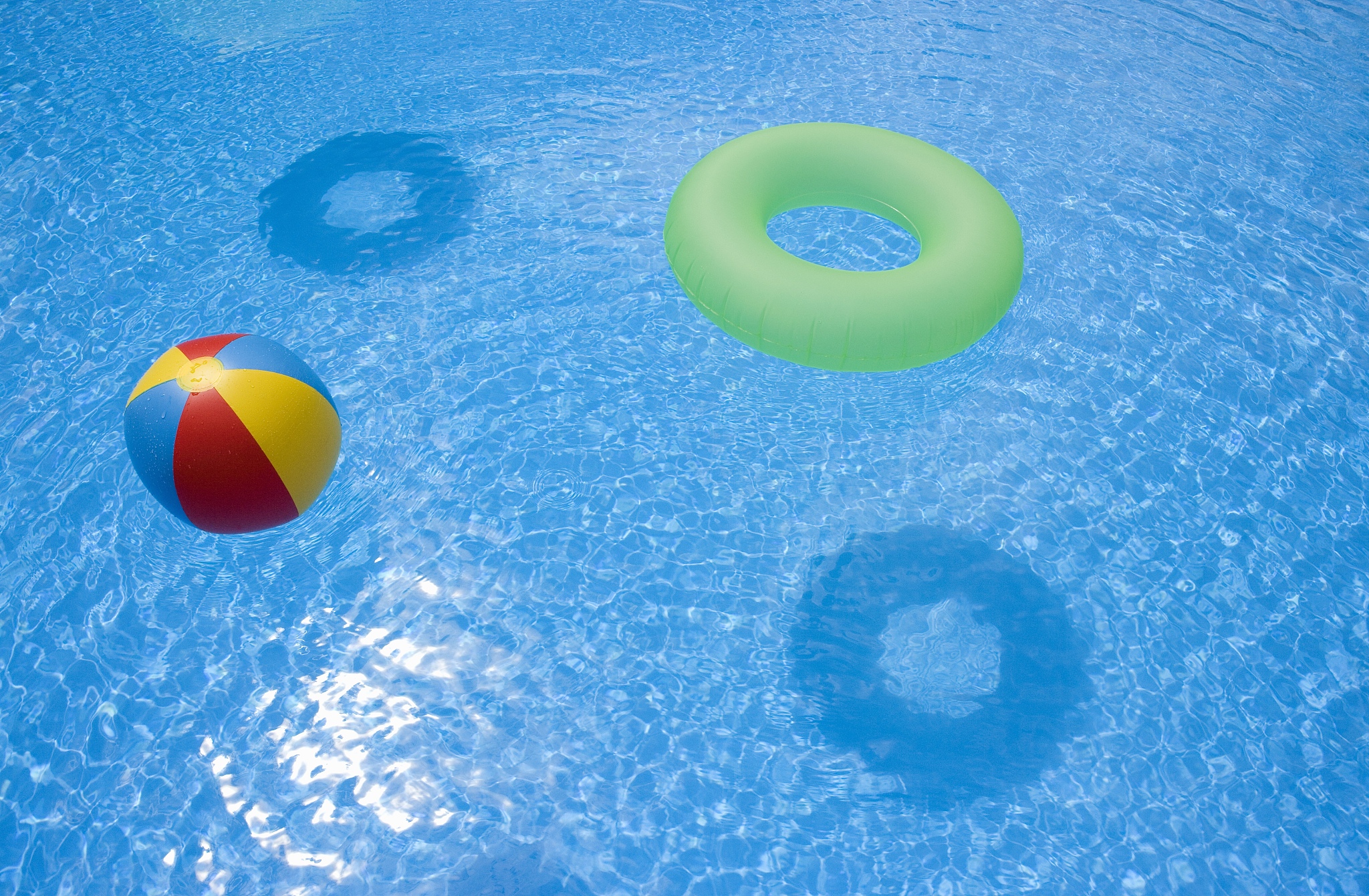 an inflatable ball and ring floating in a swimming pool