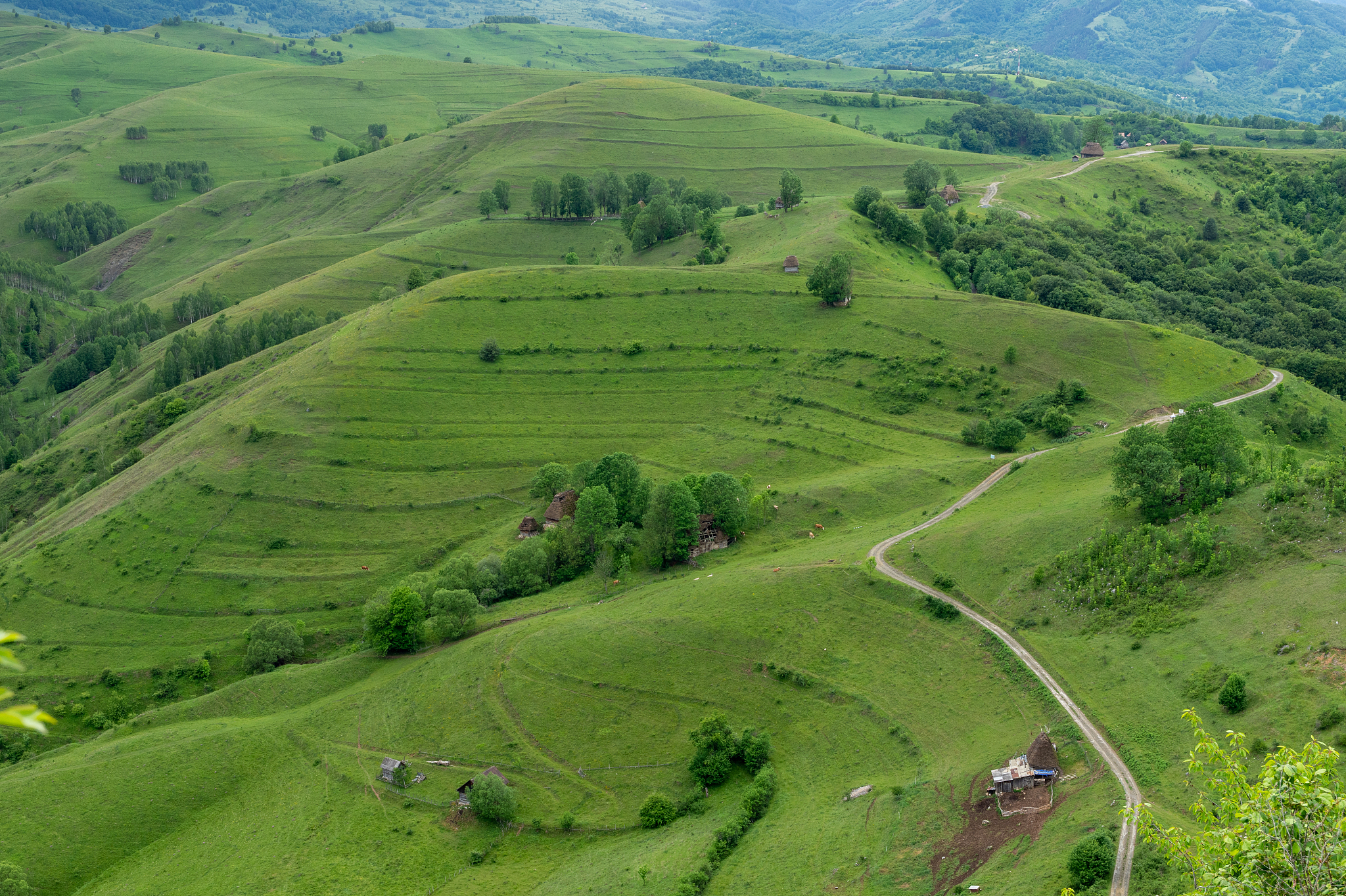 view of small farm from above and a country road
