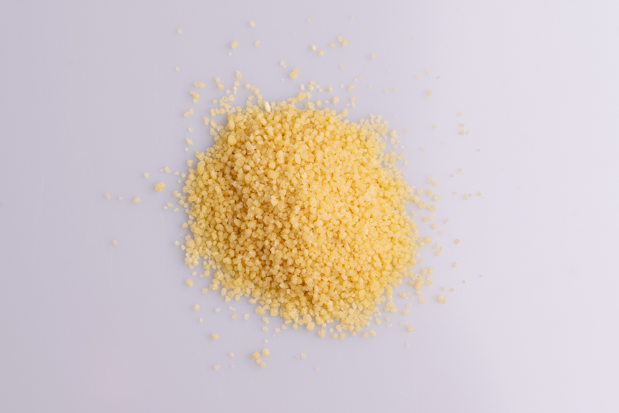 dry couscous isolated on white background, soft light, copy spac
