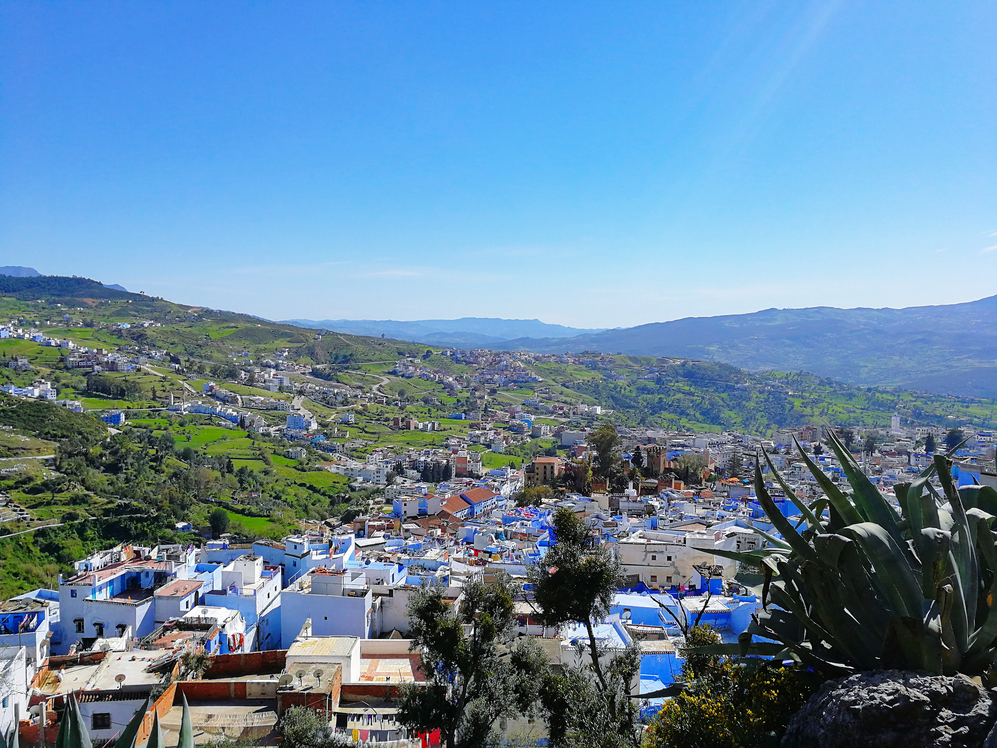aerial view of townscape against blue sky