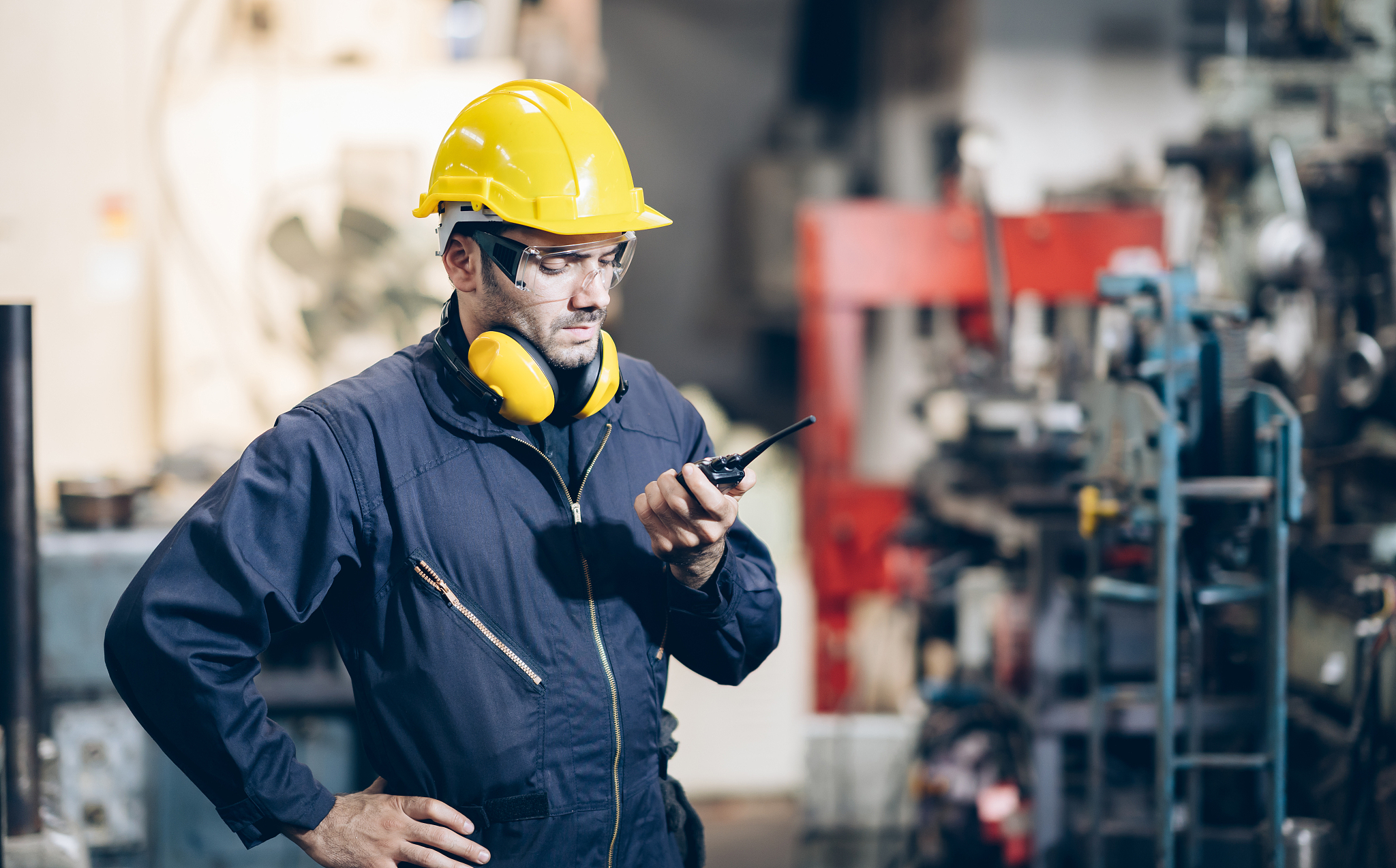 engineer man command to portable radio in factory