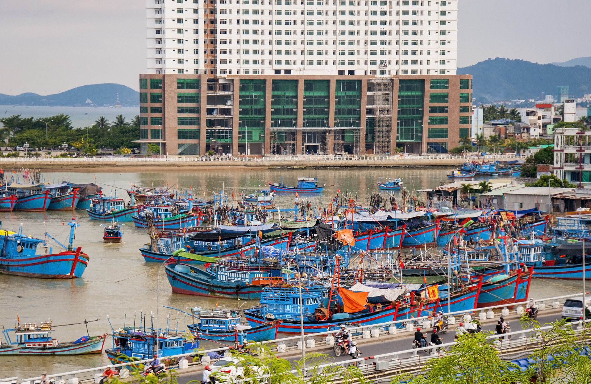 colorful fishing boats in vietnam, next to the fishing village.