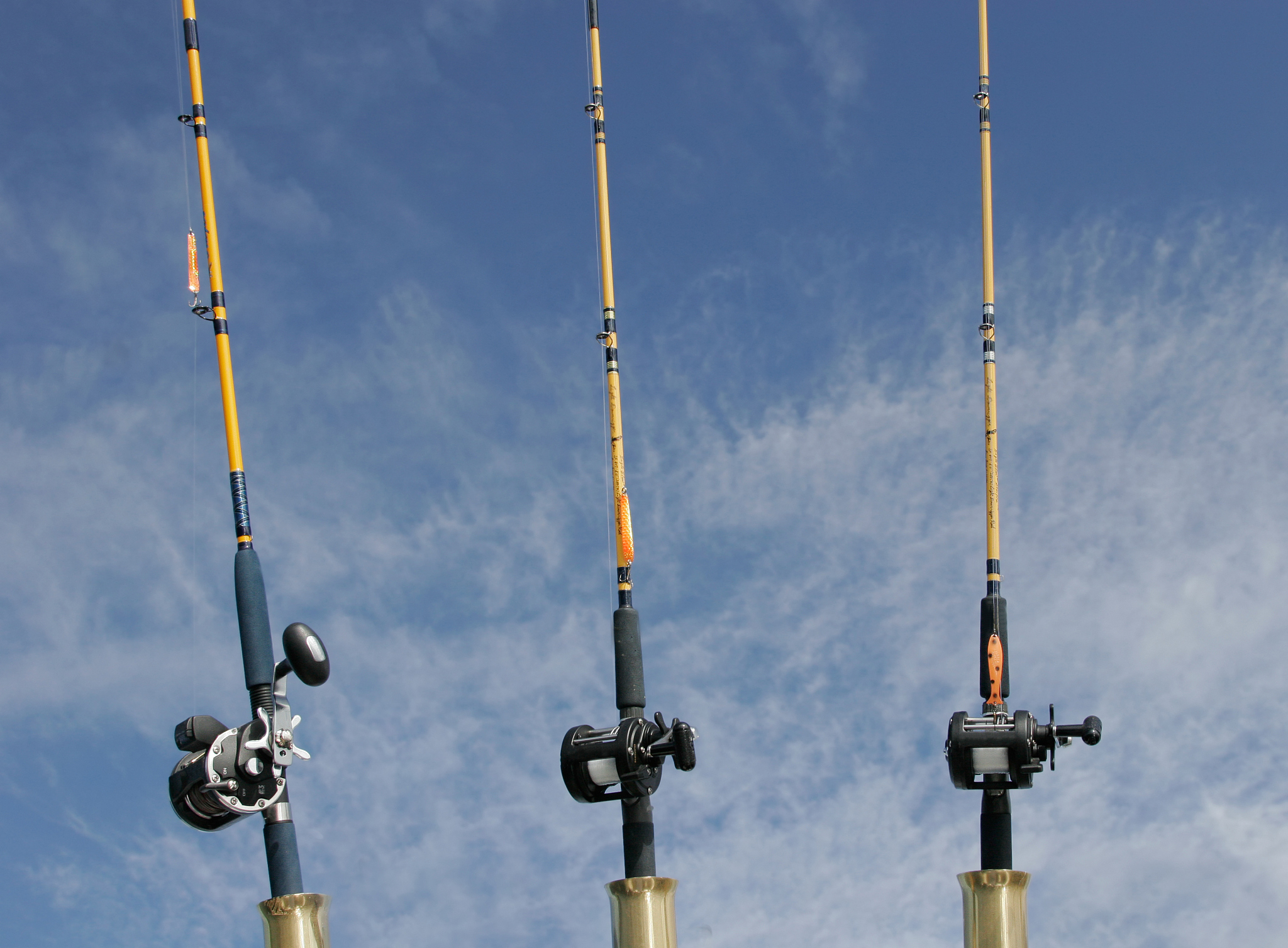 three fishing poles and clear blue sky
