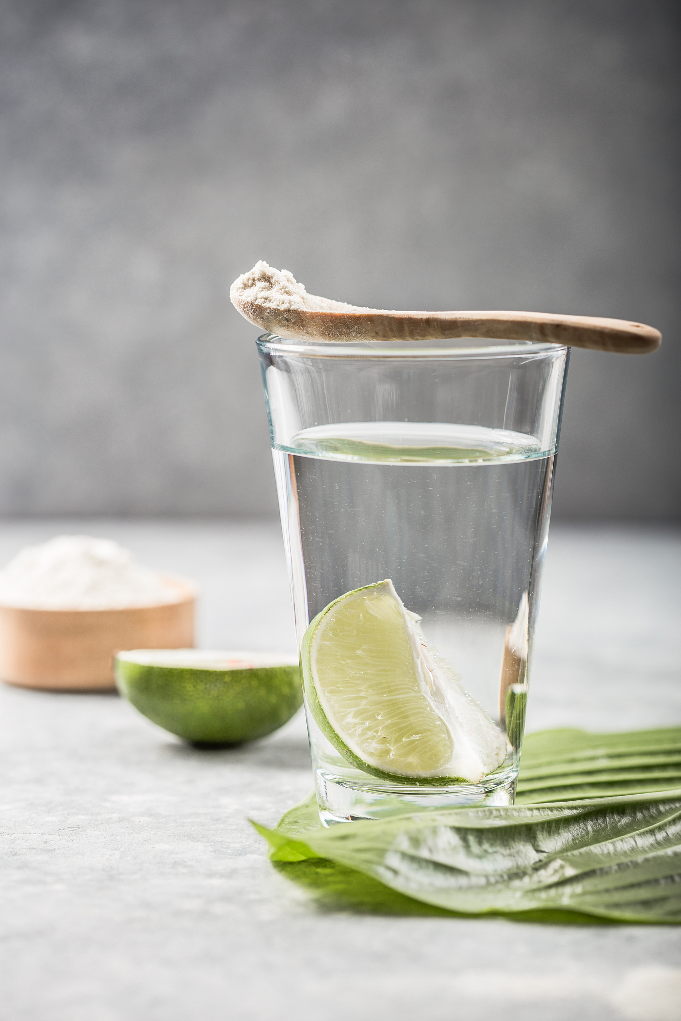 collagen powder and glass of water with  slice of lime; vitamin 