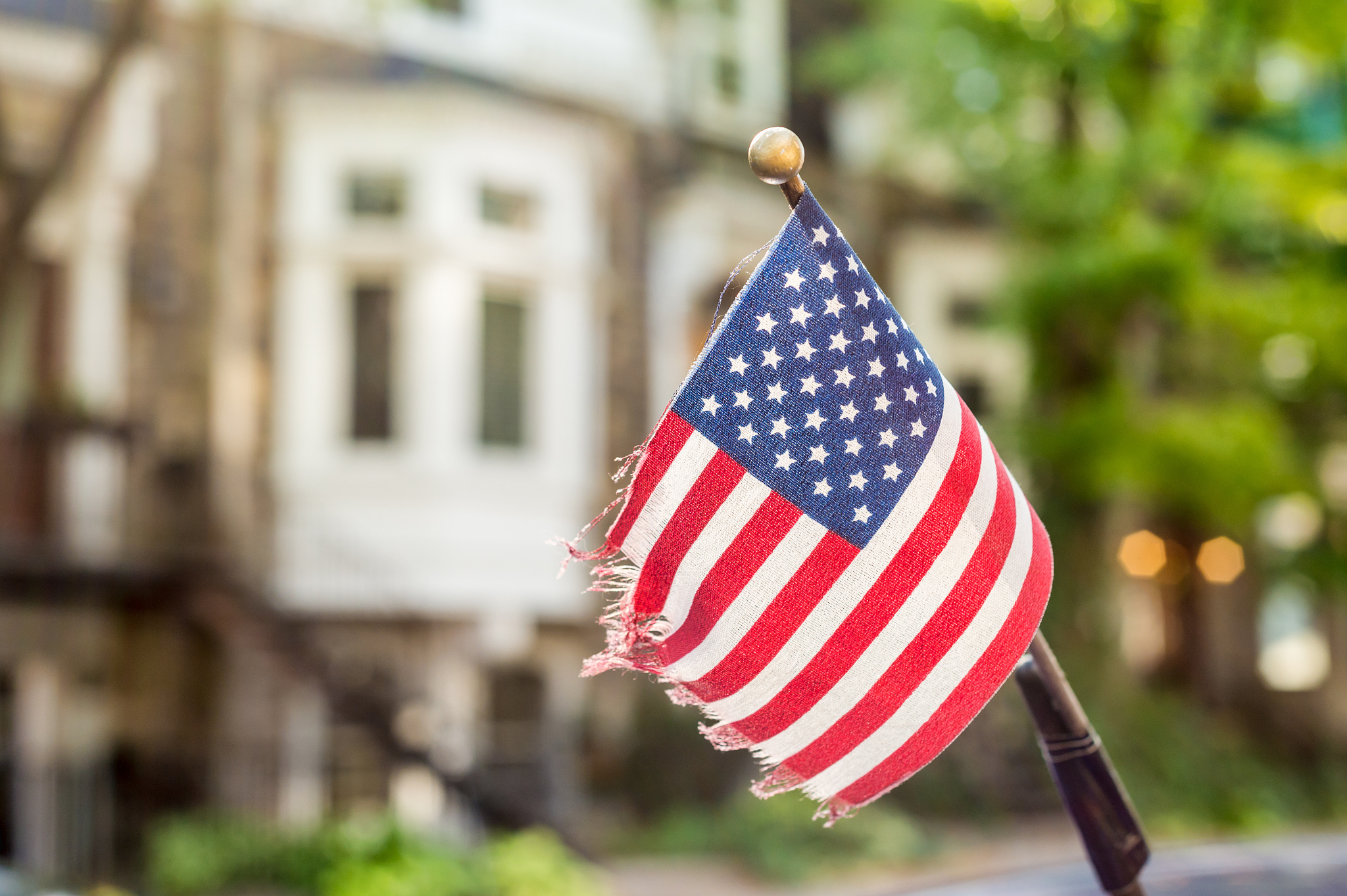 american flag on a car antenna