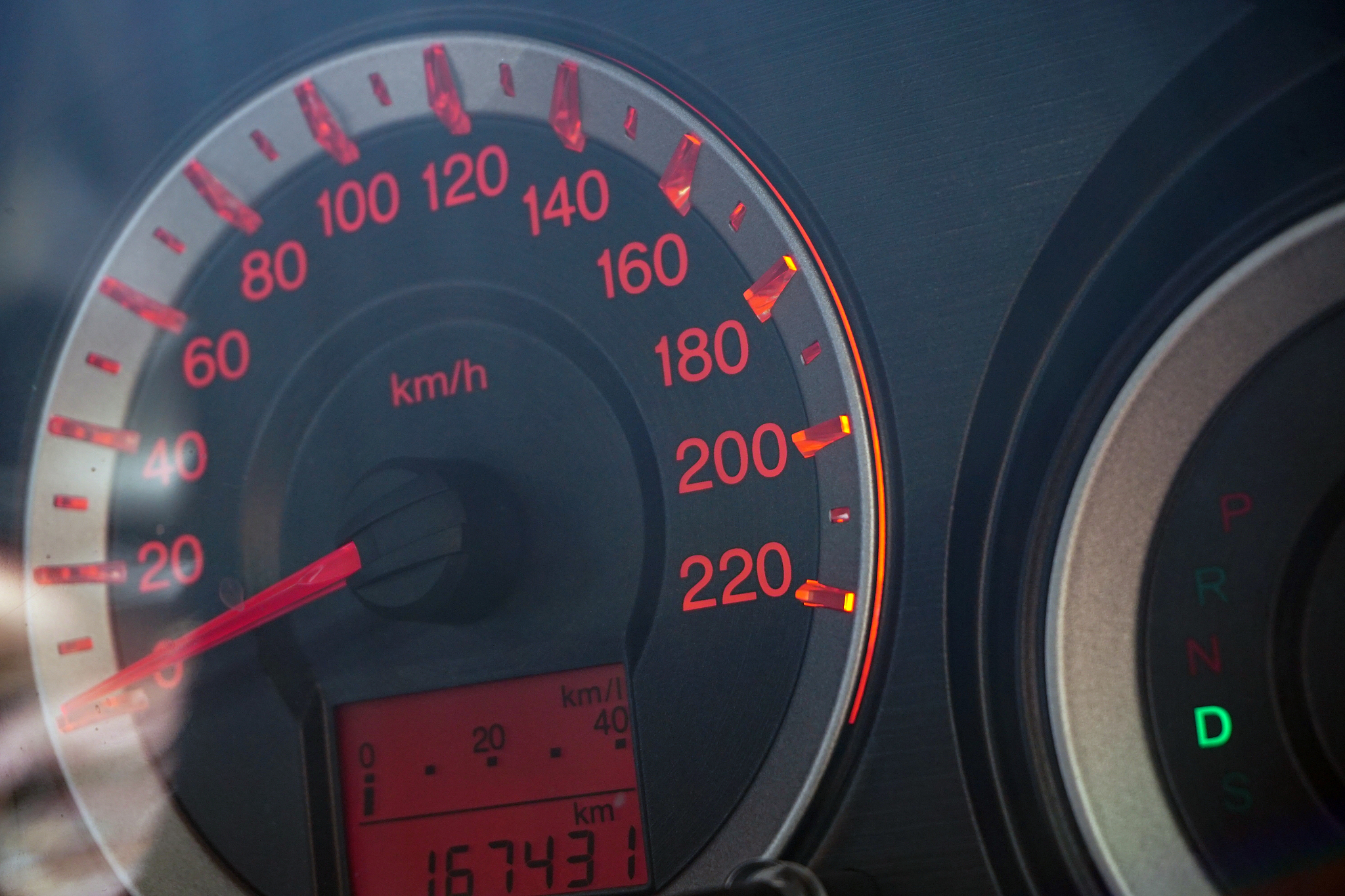 close-up of red speedometer in car