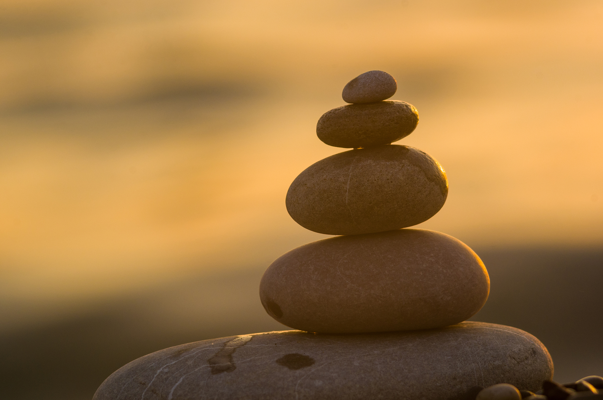 stack of zen stones on pebble beach