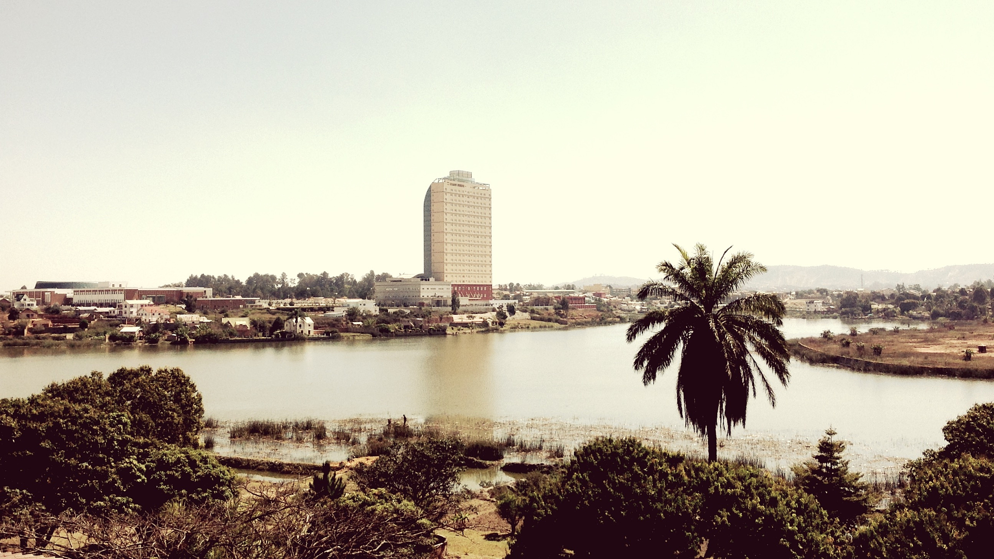 view of lake and buildings against clear sky
