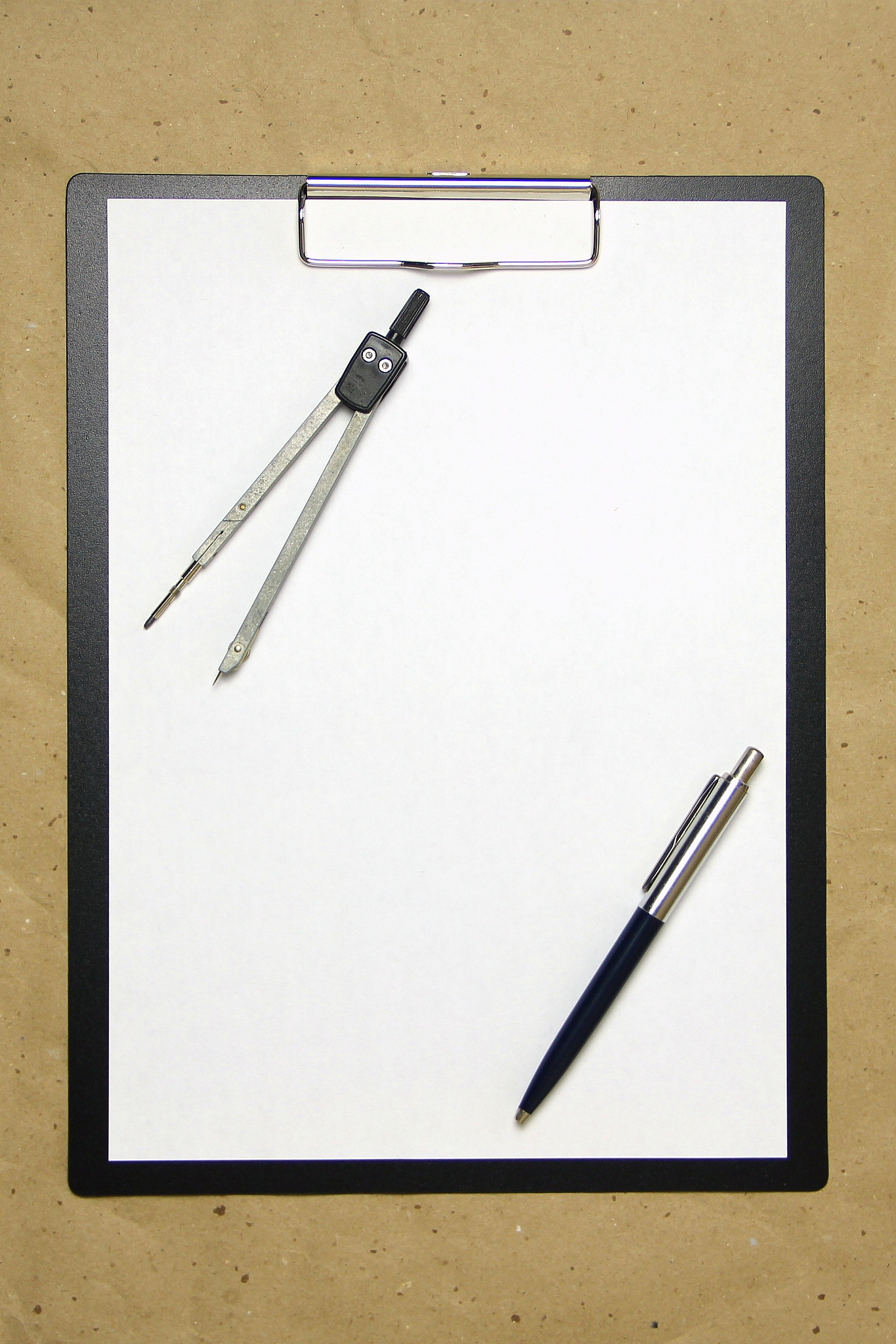 a tablet with a white sheet of a4 format on a beige craft paper