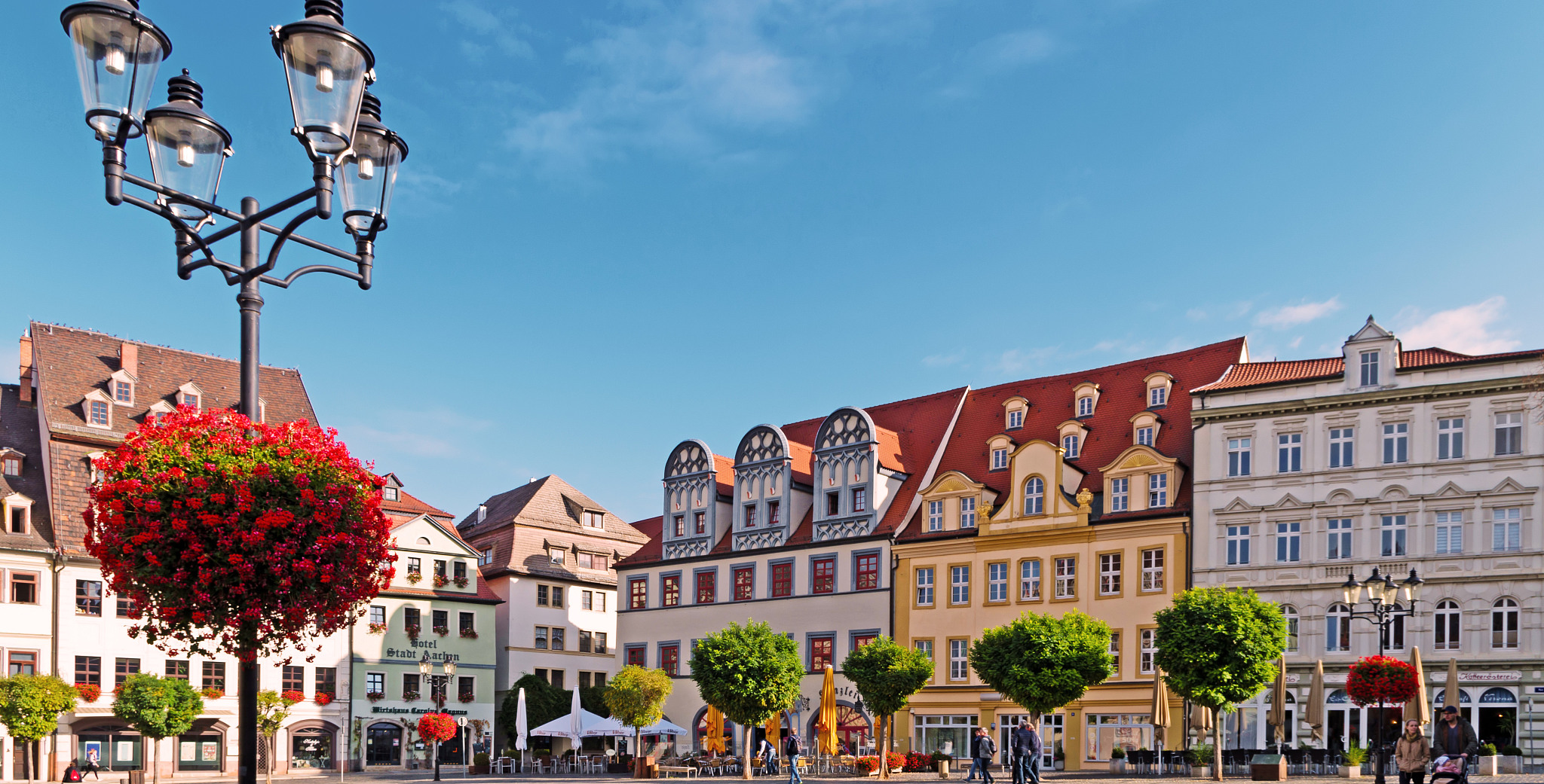 people on street by buildings against sky
