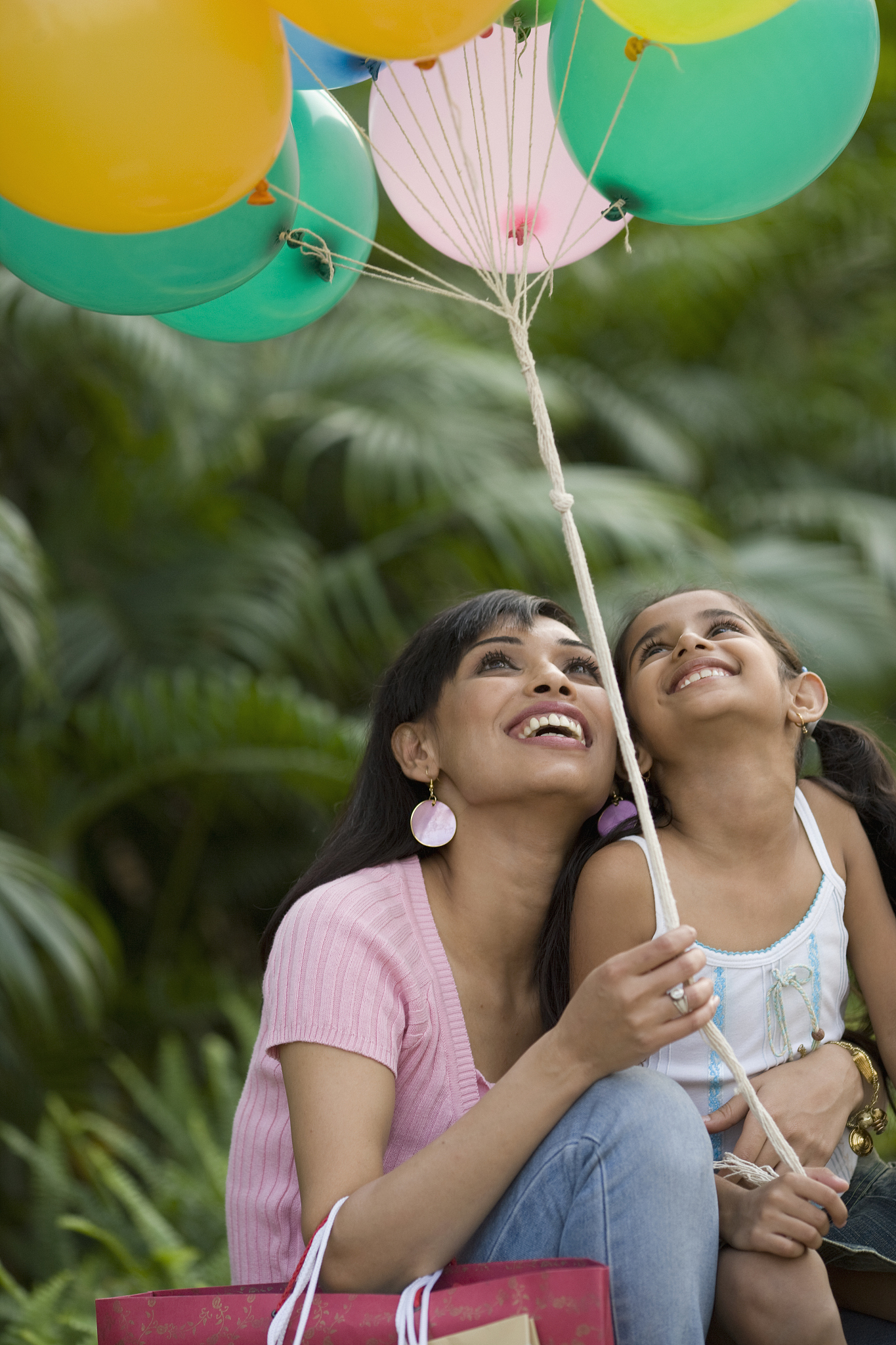 mother giving daughter balloons