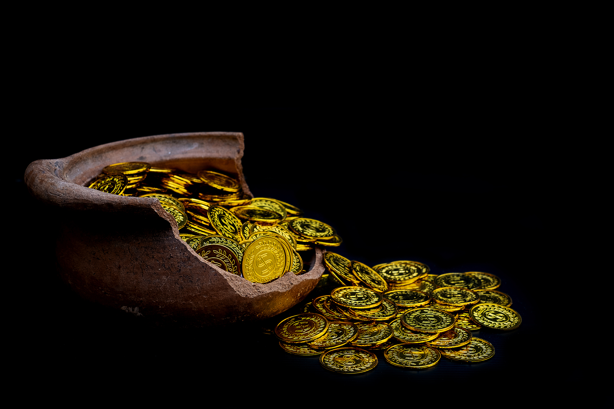stacking gold coin in broken jar on black background,  money sta