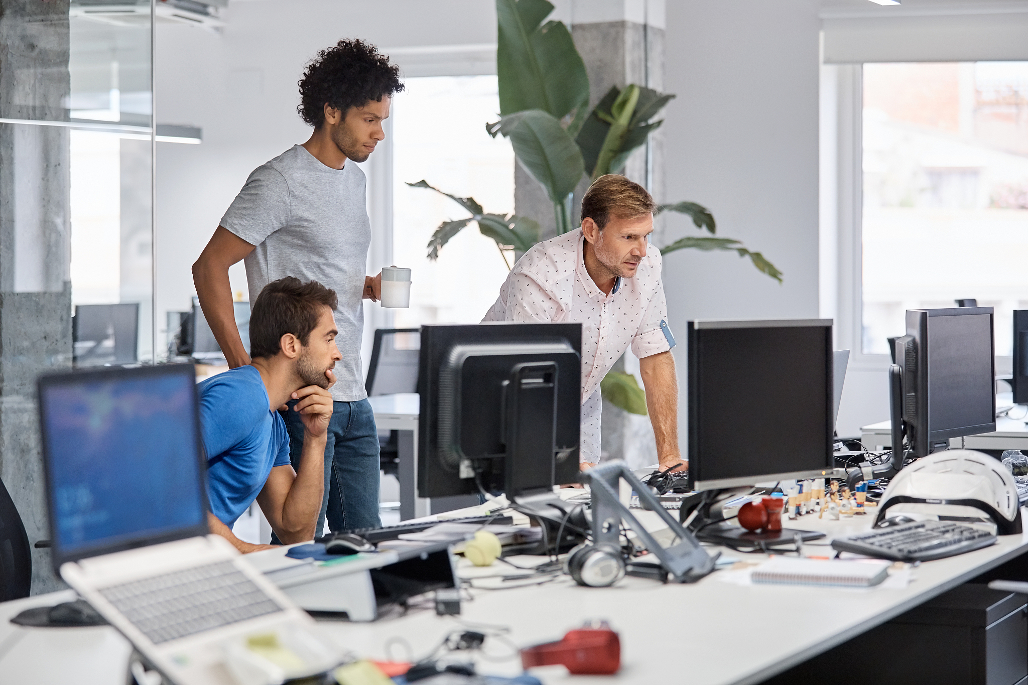 multi-ethnic businessmen using computer at desk