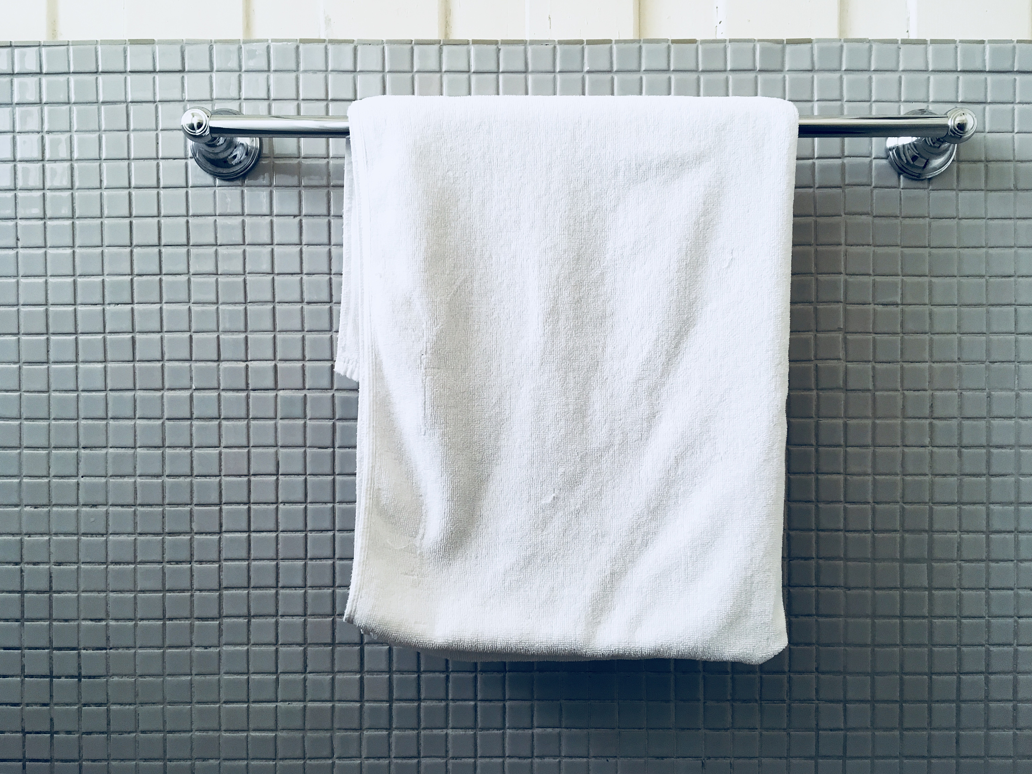towel hanging on tile wall