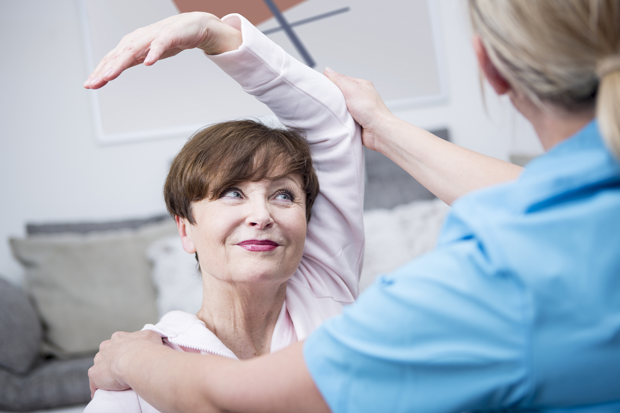 gereatric nurse doing physio therapy with patient