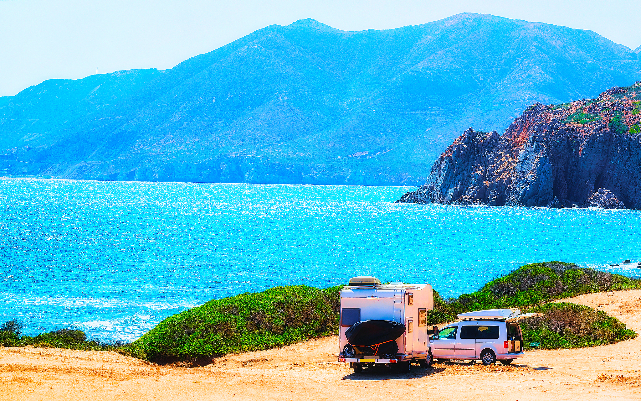 car and camper at capo pecora mediterranean sea sardinia reflex