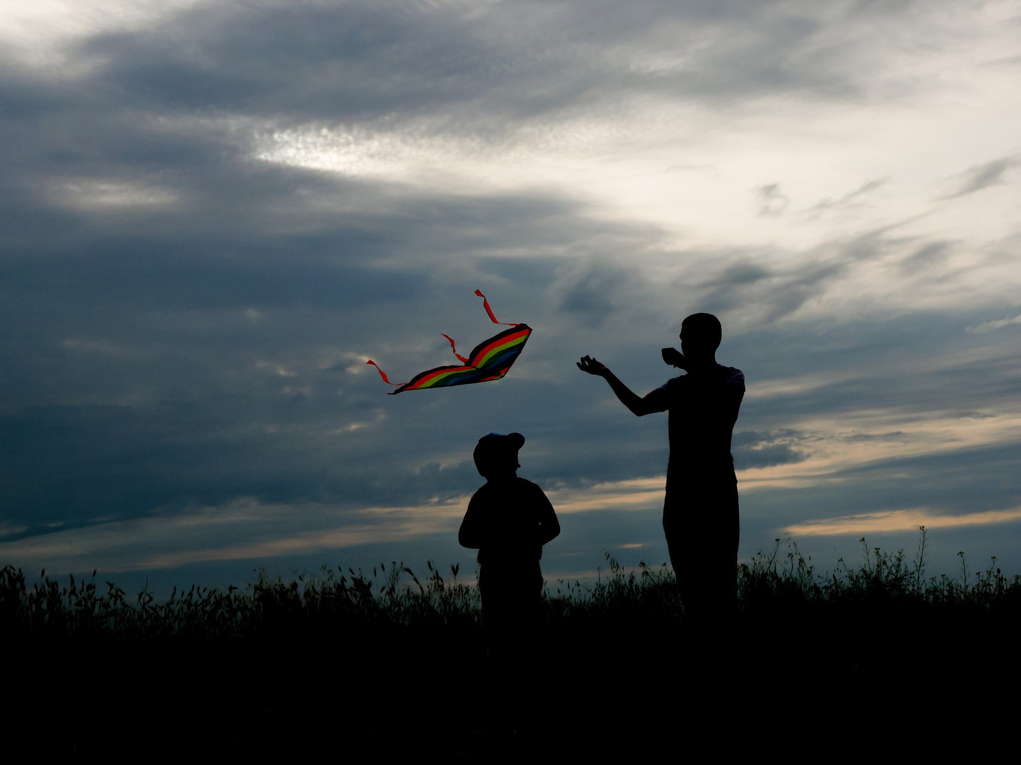 father and son launch a kite