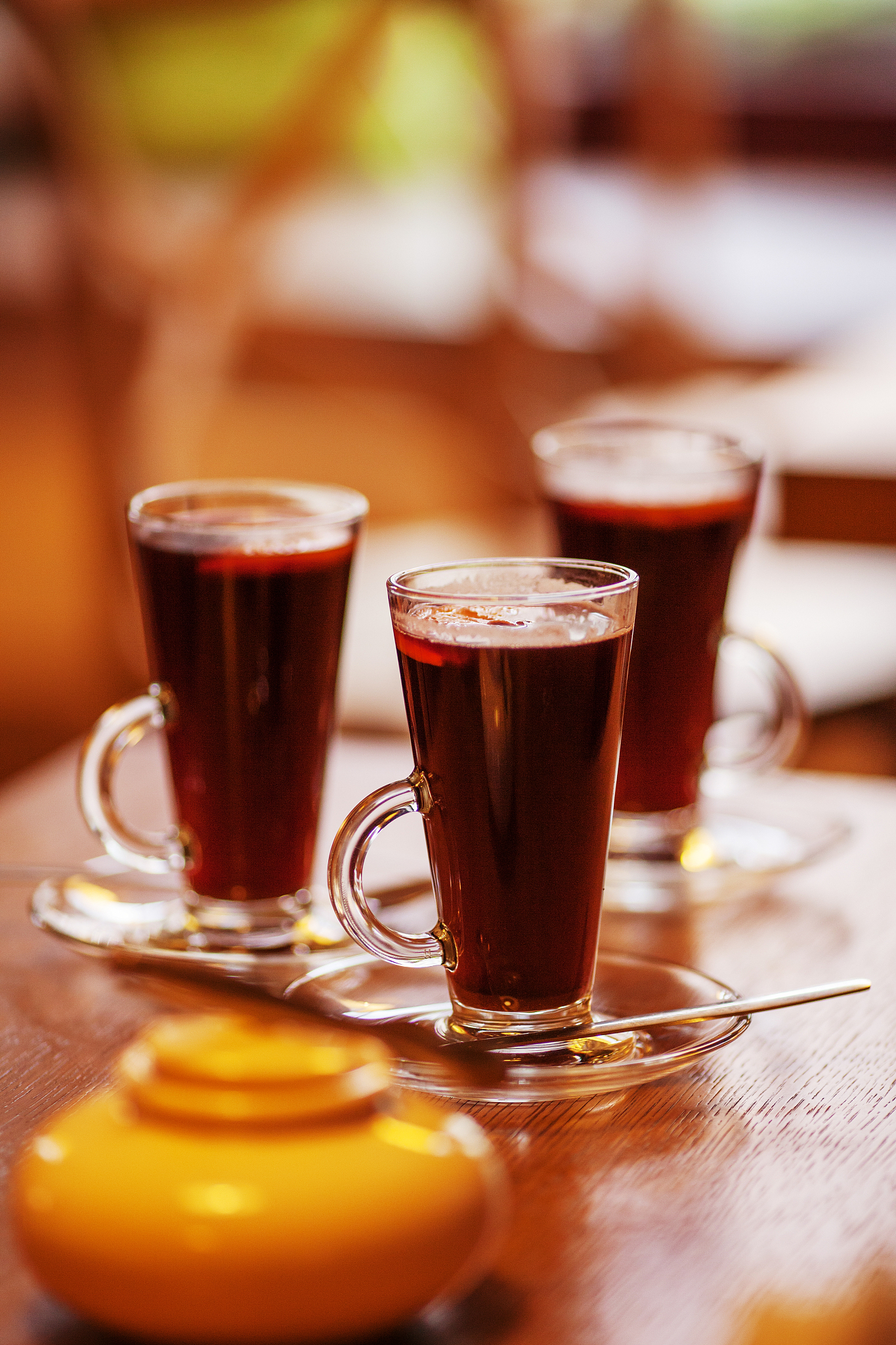 three glasses of red hot drink. mulled wine or tea. warm atmosph
