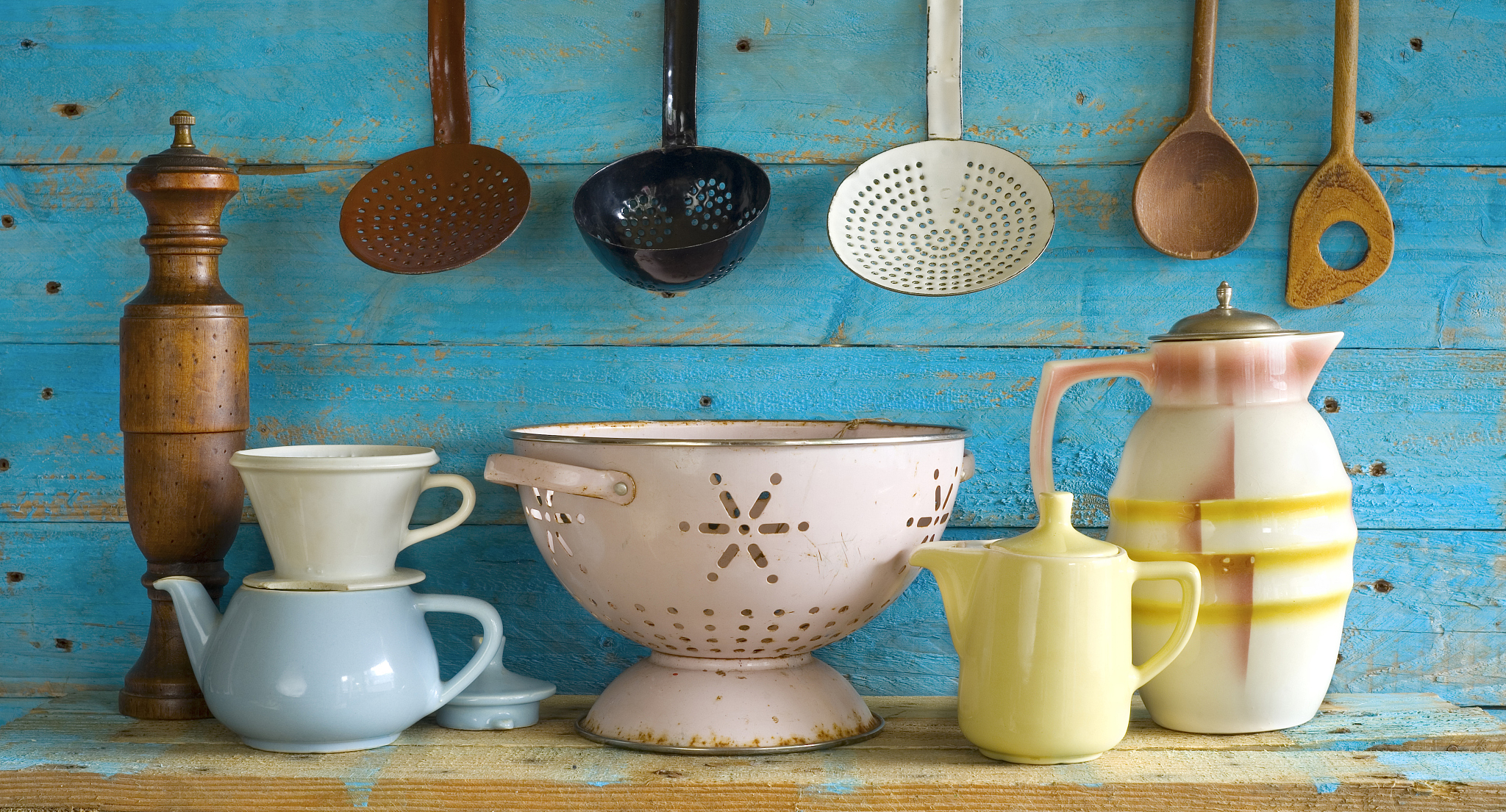 various vintage kitchen utensils,against blue wooden wall