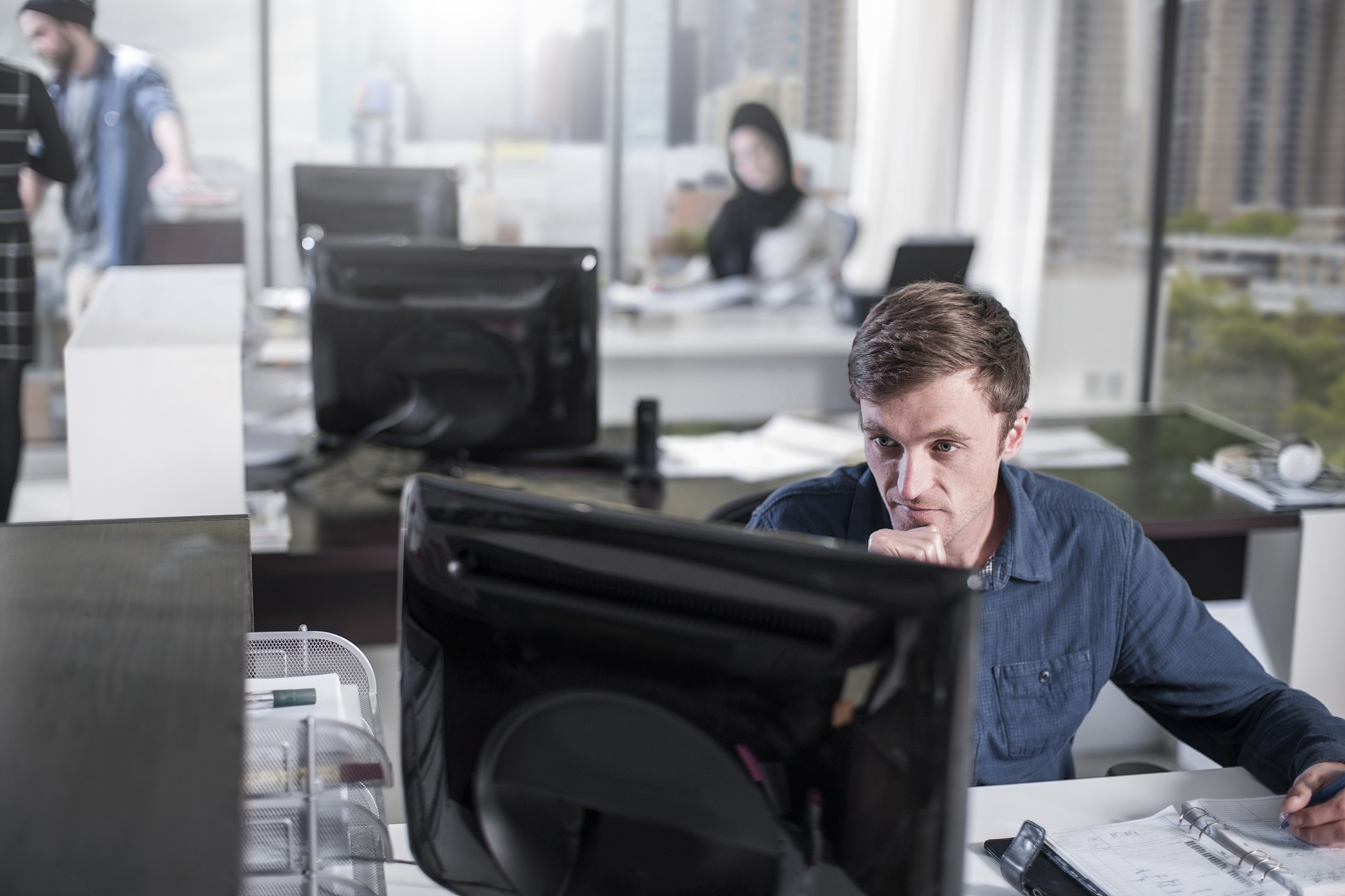 man working on computer in office