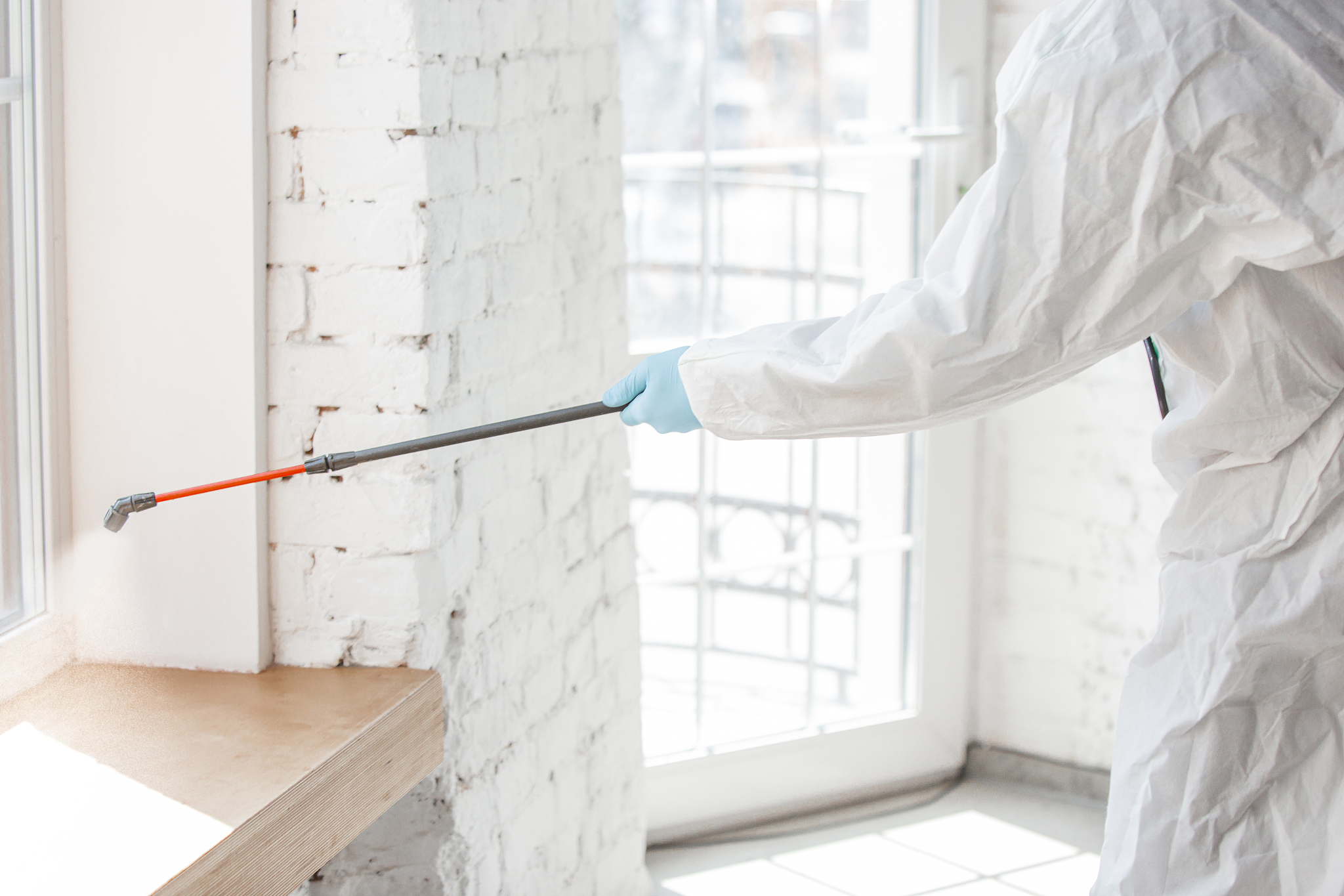 coronavirus pandemic. a disinfector in a protective suit and mas