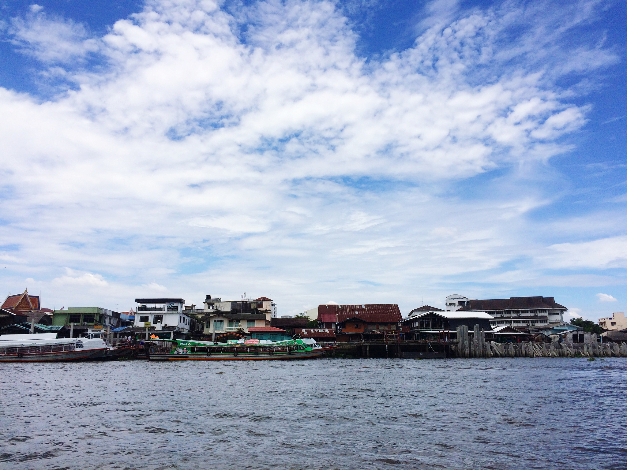 buildings by sea against sky
