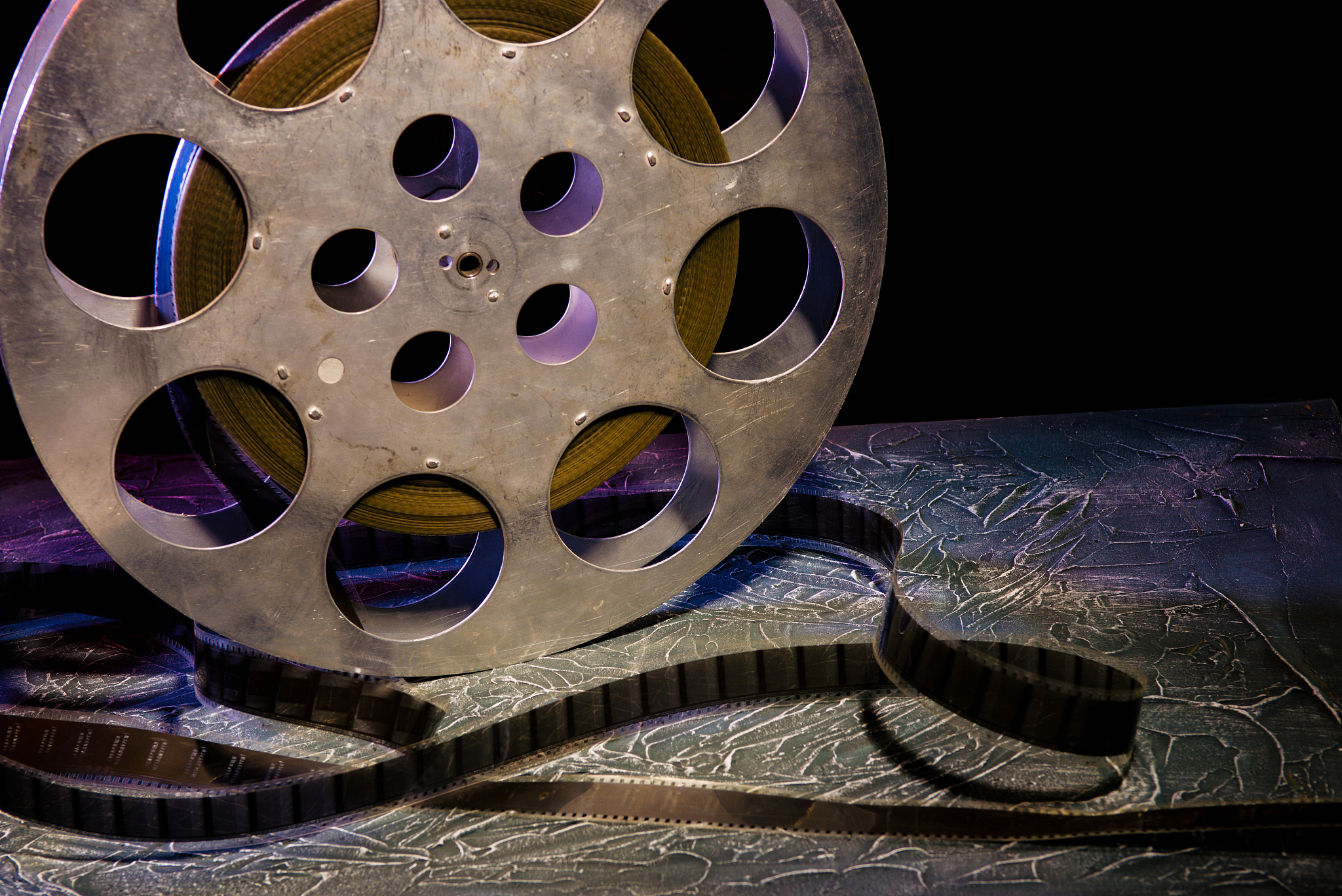35 mm film reel with dramatic lighting on a dark background
