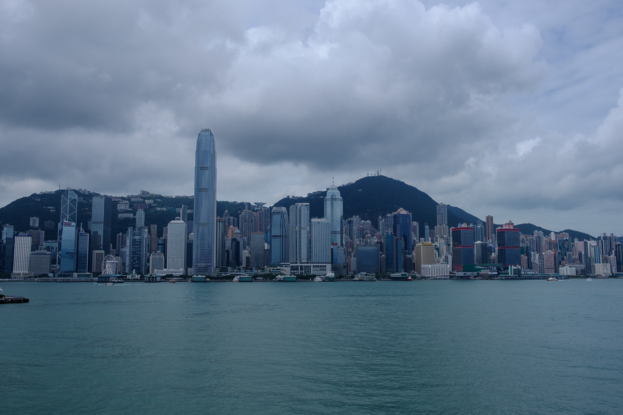 city at waterfront against cloudy sky