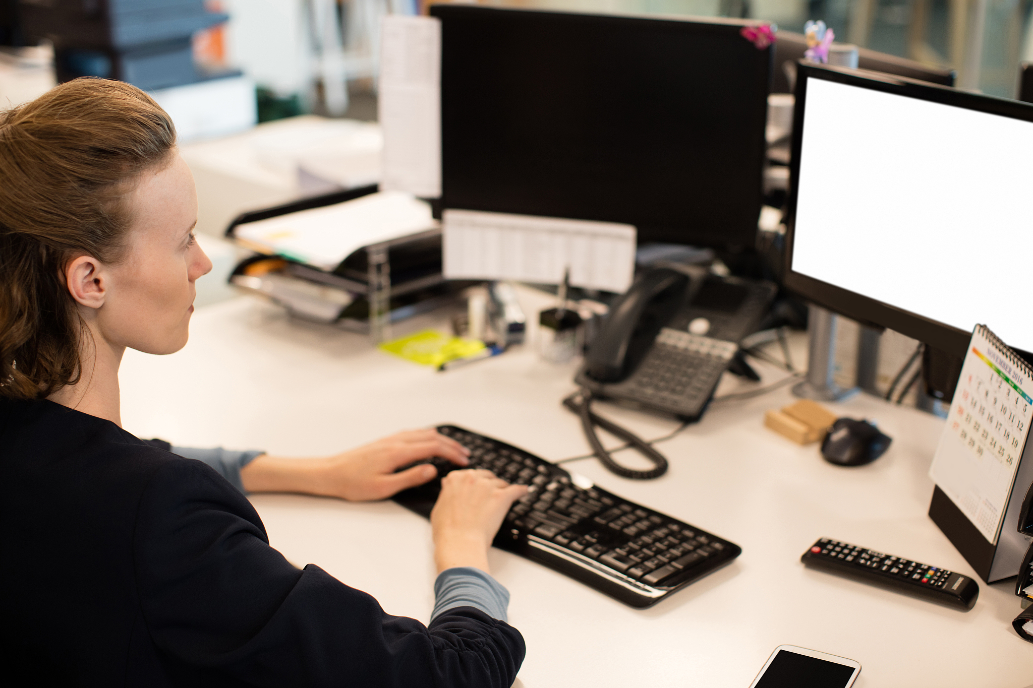 high angle view of businesswoman working on computer at desk in 
