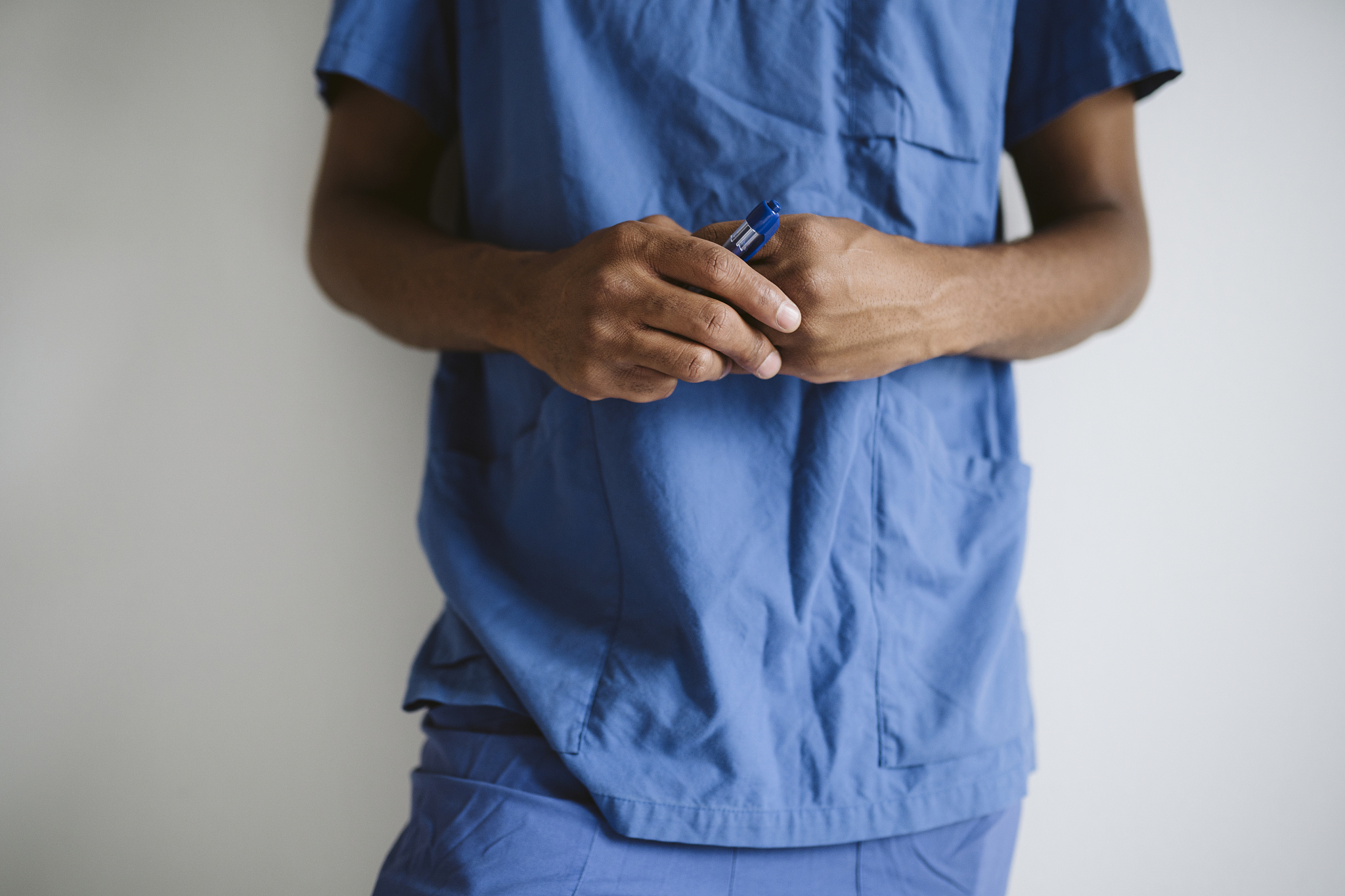 man wearing scrubs, mid section