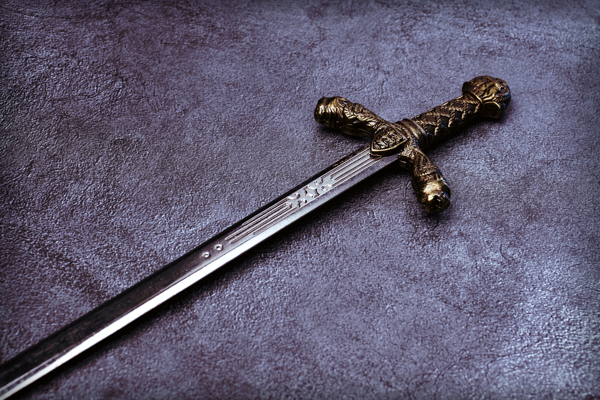 knight's hilt on a gray marble background