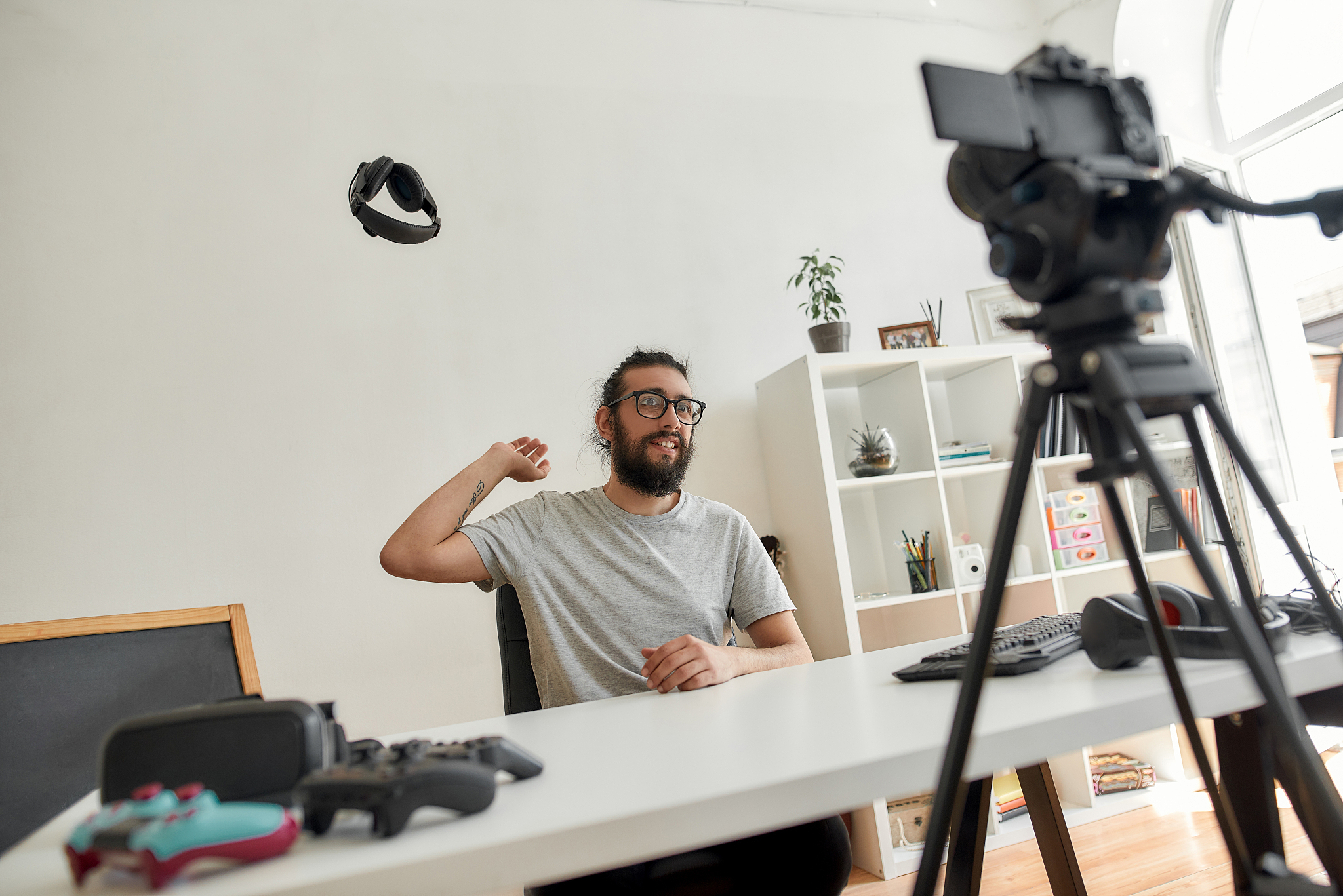 male technology blogger throwing away headphones, dissatisfied w