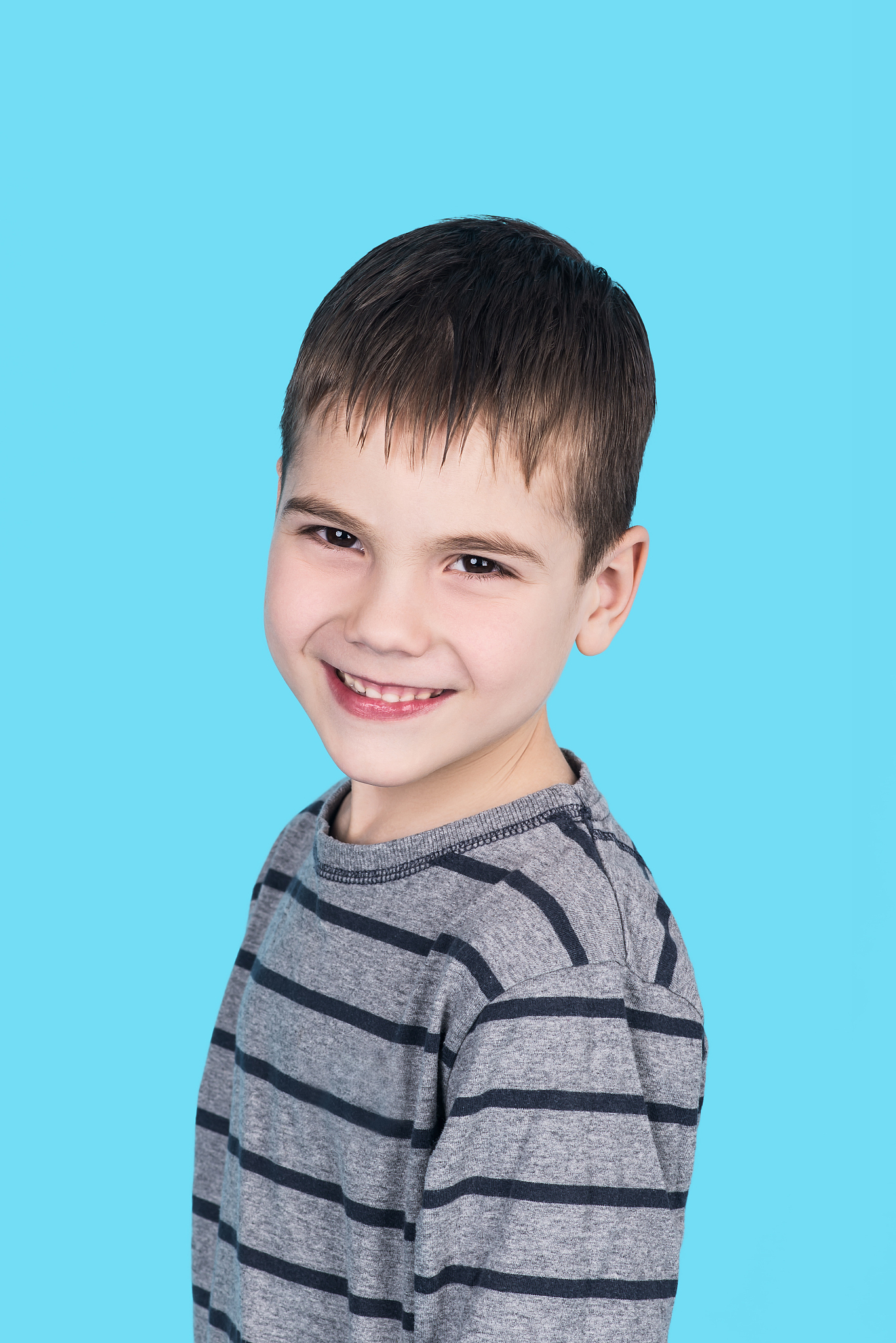 portrait of smiling child boy, isolated on blue
