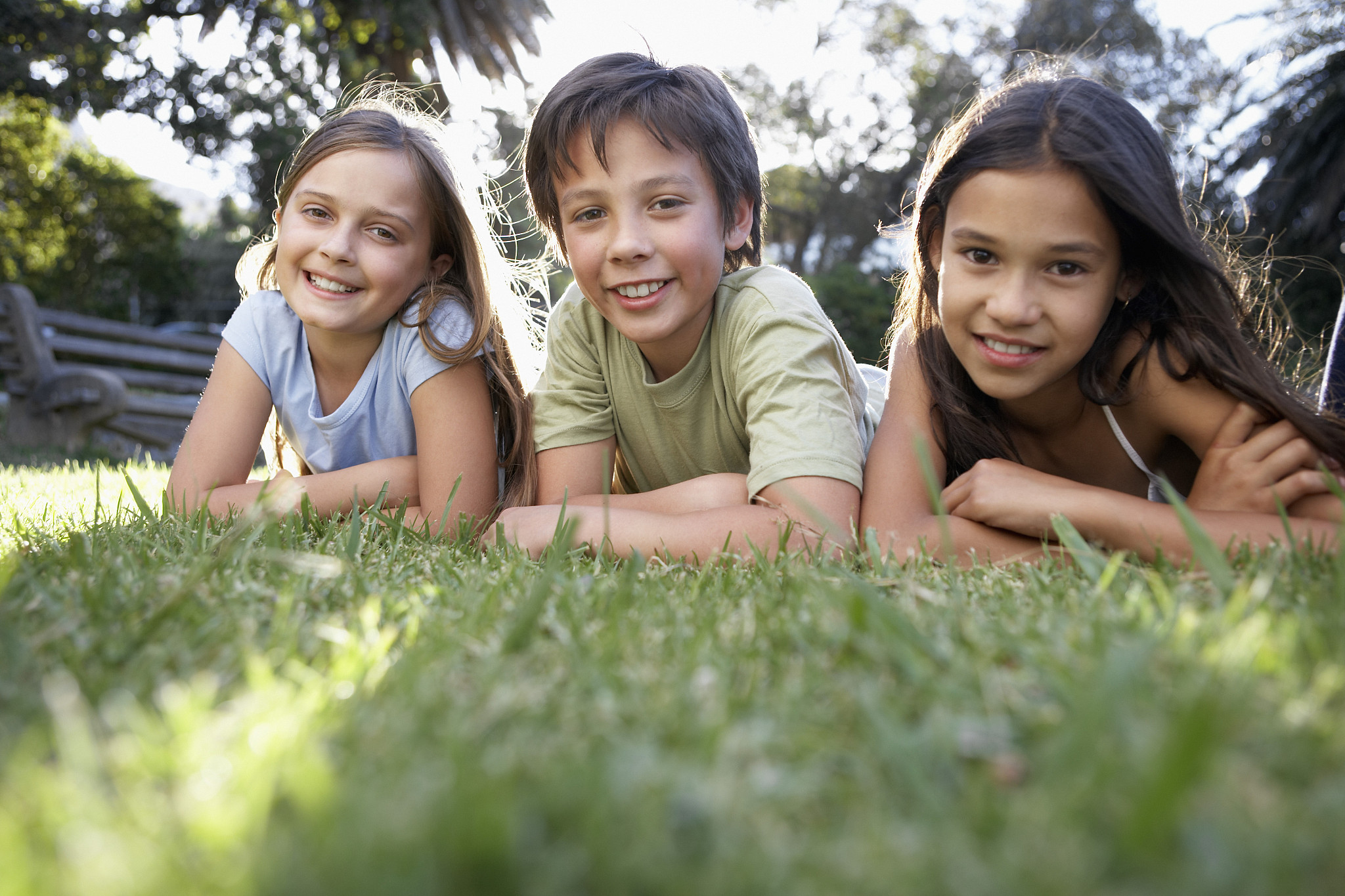 group of children lying in grass