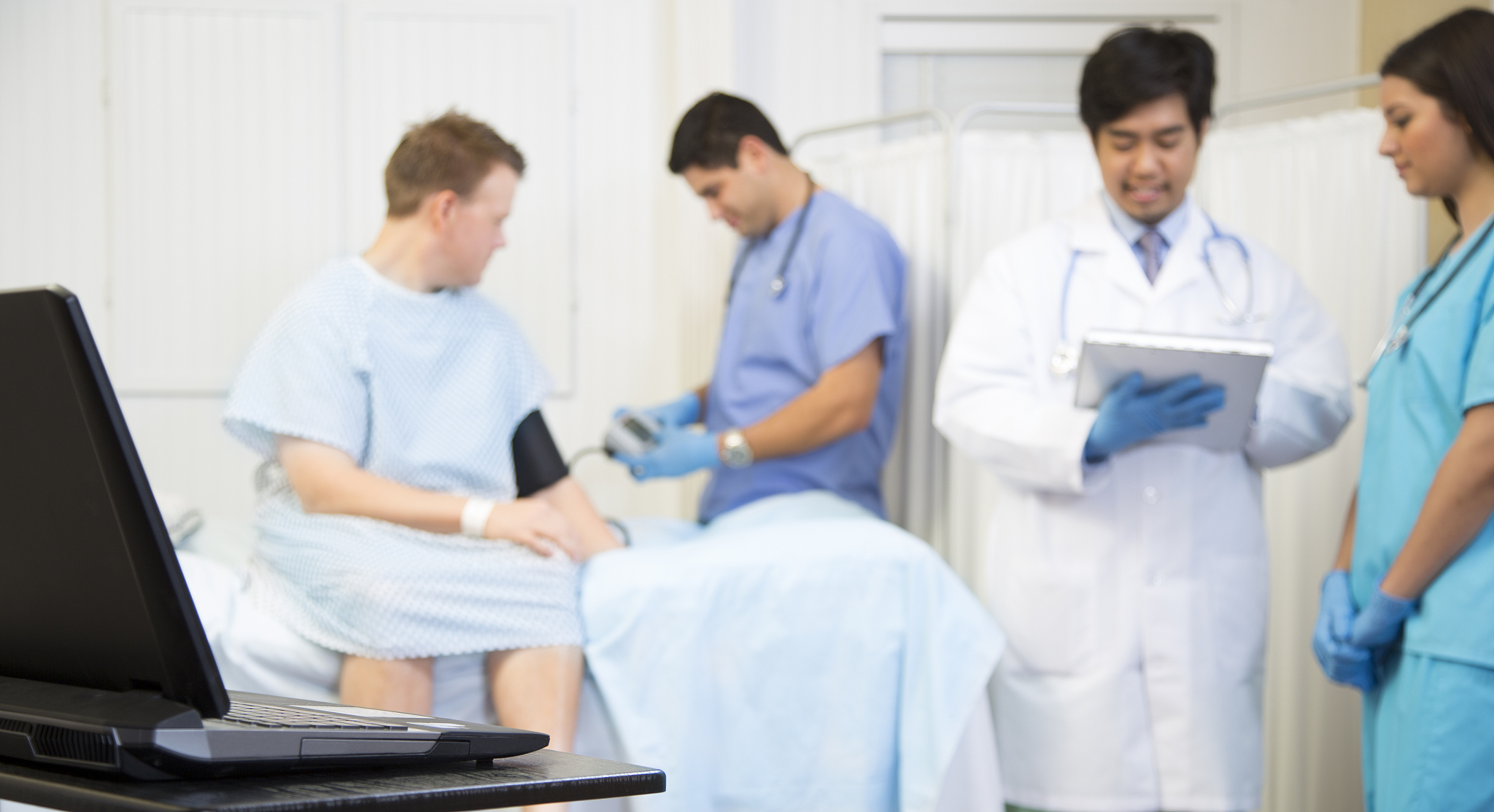 healthcare: medical staff conduct patient exam in hospital.